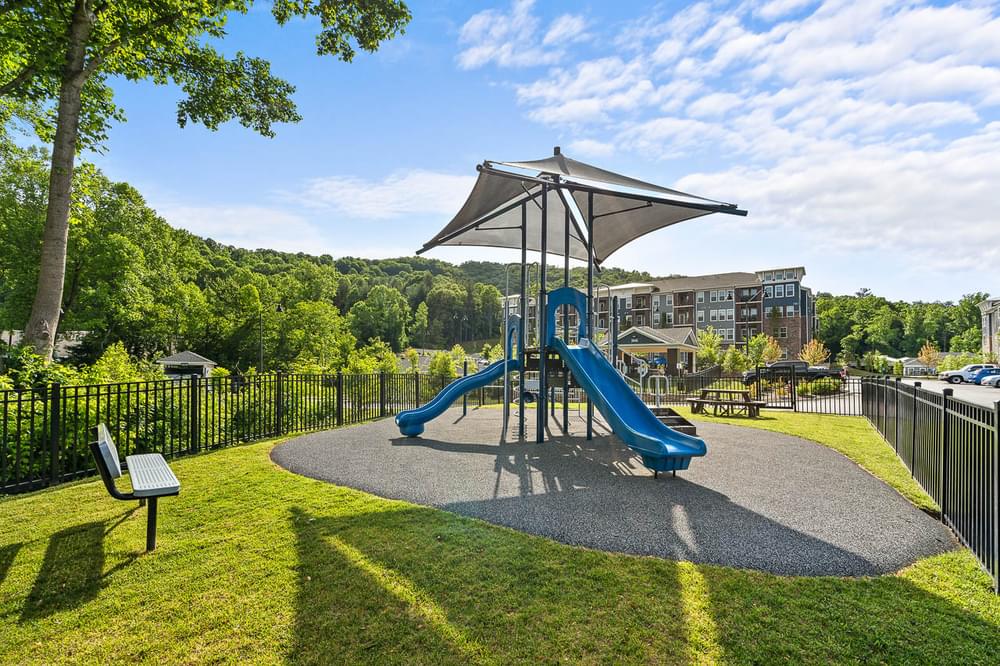 a playground with a blue slide in a park