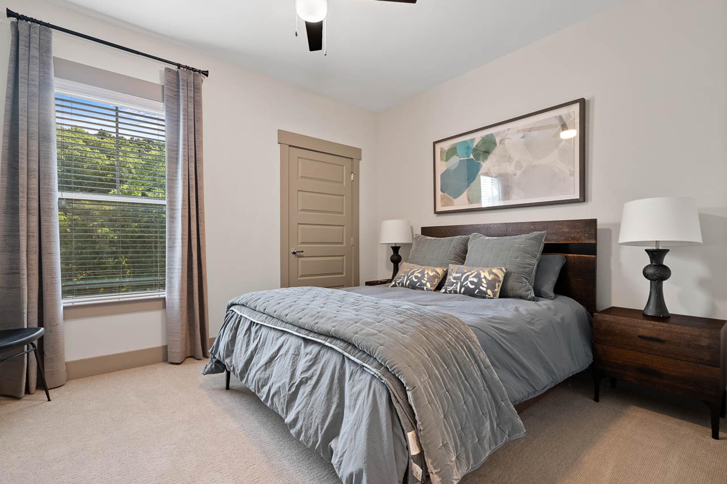 a bedroom with a bed and a window