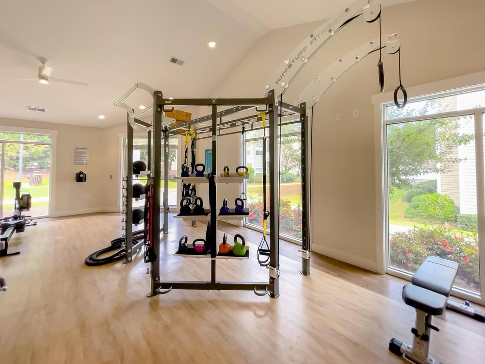 a home gym with weights and a large window