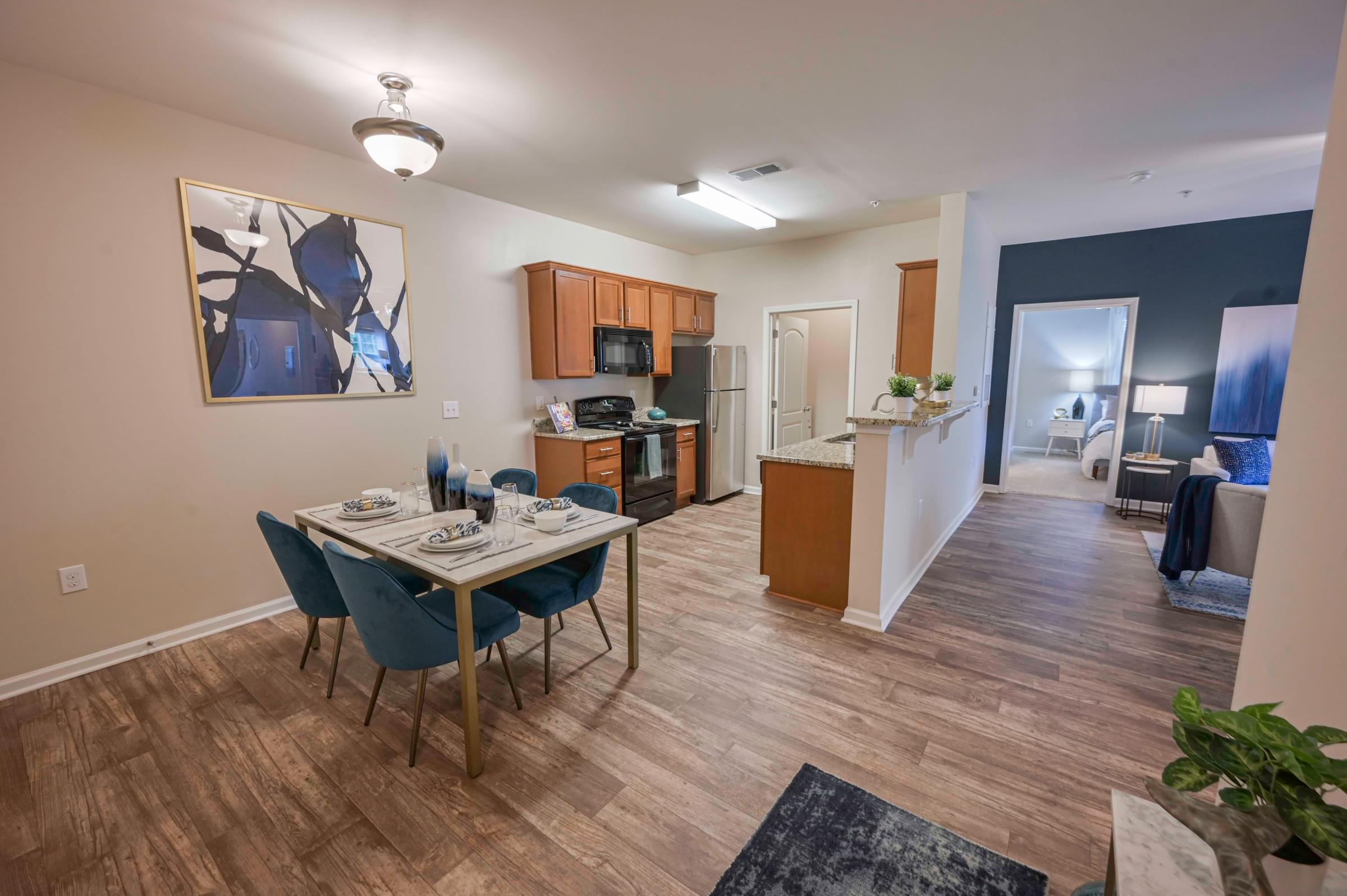 Dining, Kitchen and Living Room Area with Plank Wood Floors