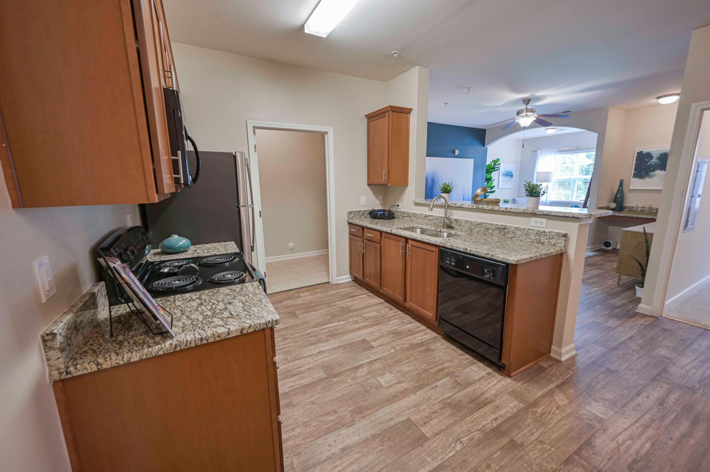 a kitchen with granite counter tops and wooden cabinets