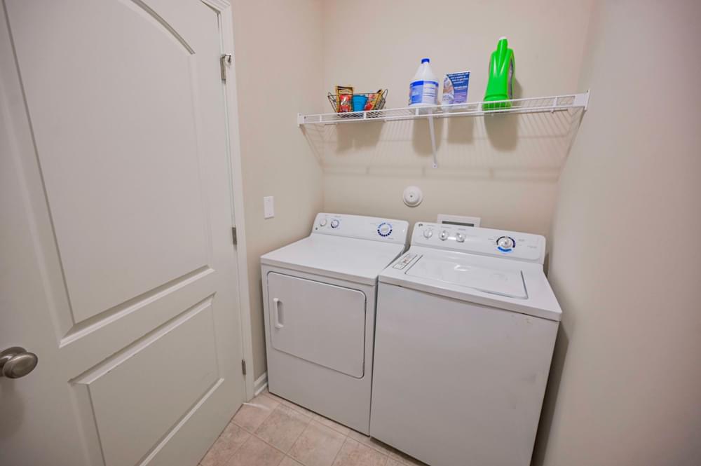 the laundry room has a washer and dryer and a door to the closet