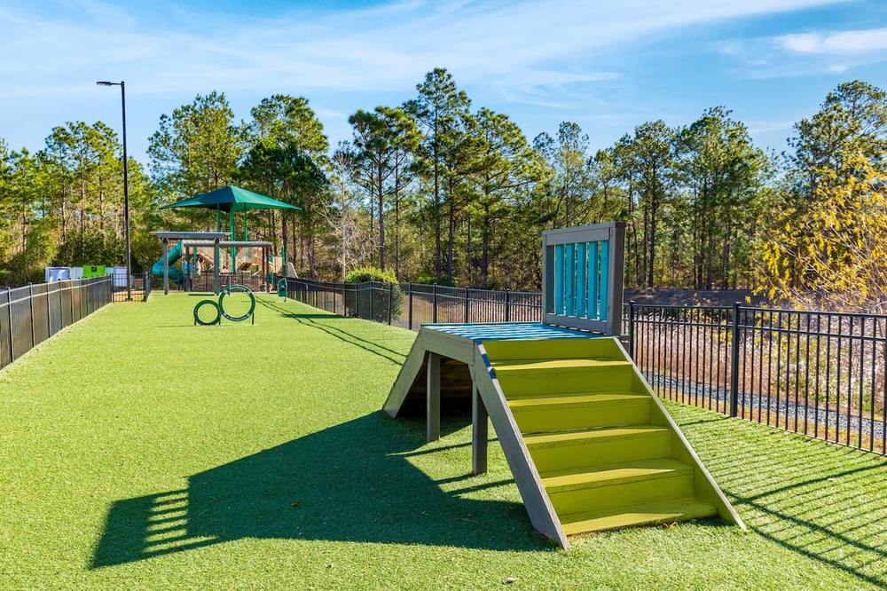 a playground with a picnic table and a swing set