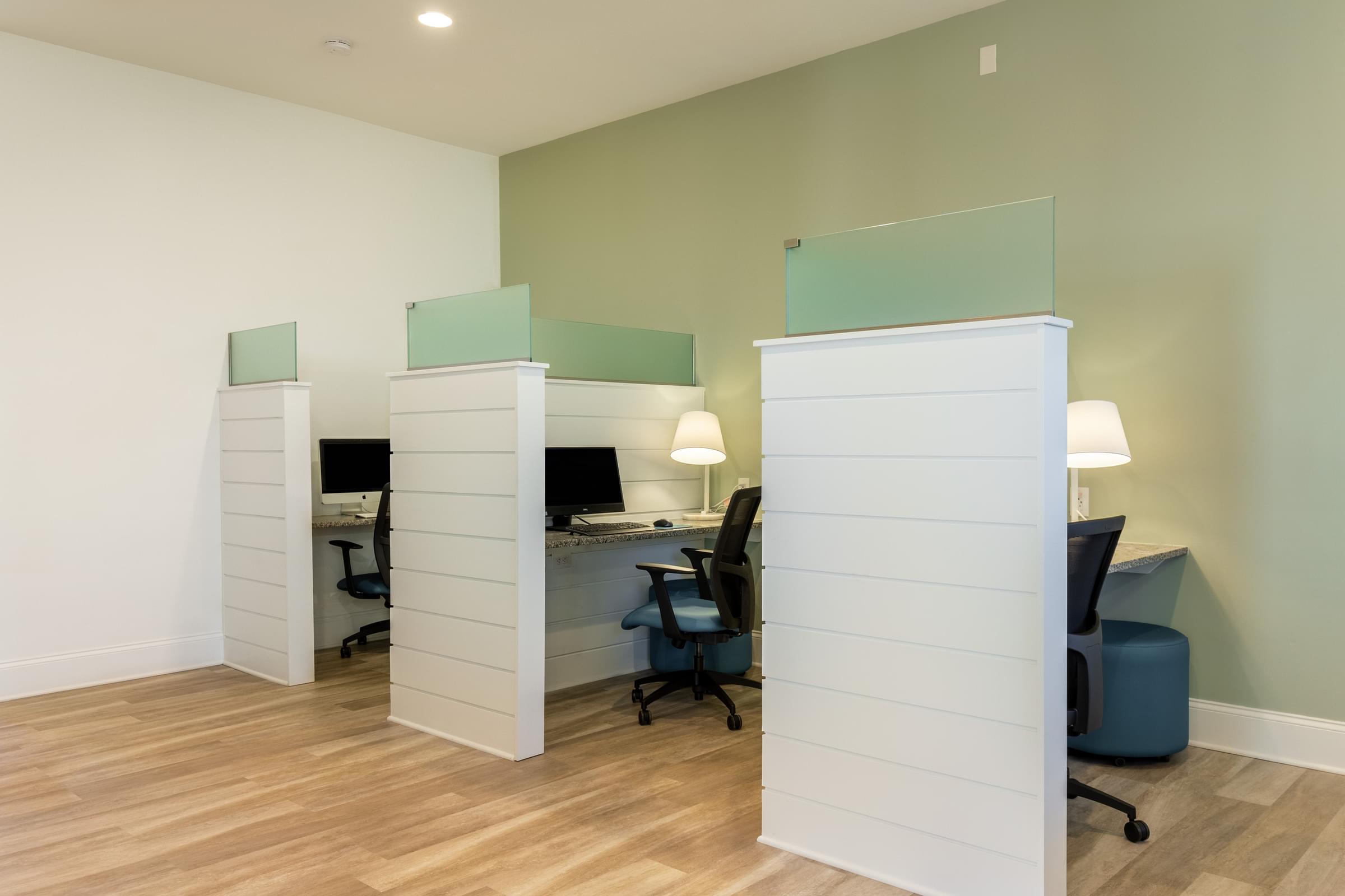 a home office with two desks and a chair