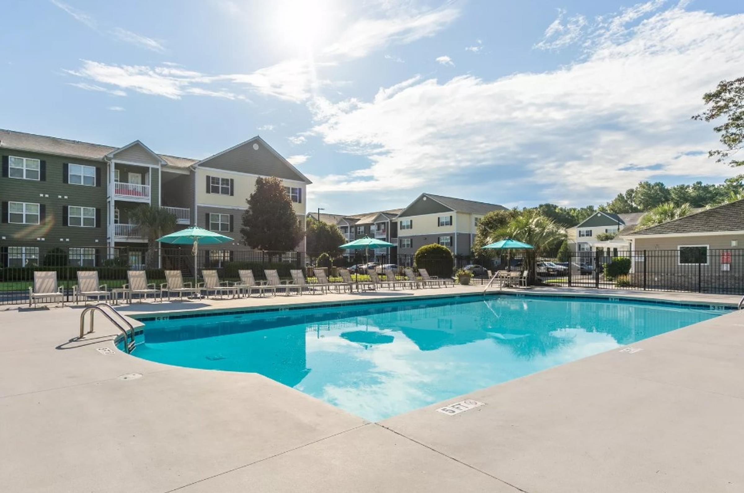 our apartments offer a swimming pool with our apartment building in the background