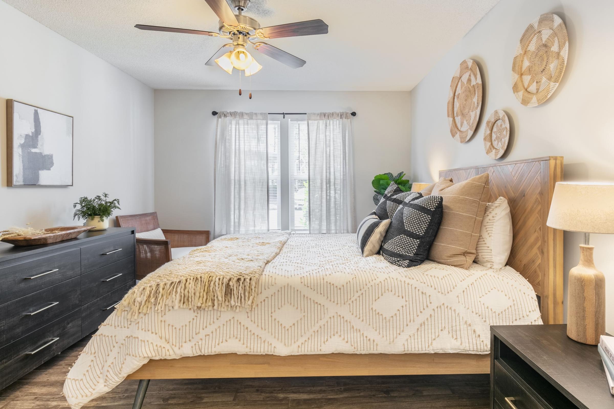 a bedroom with a bed and a ceiling fan