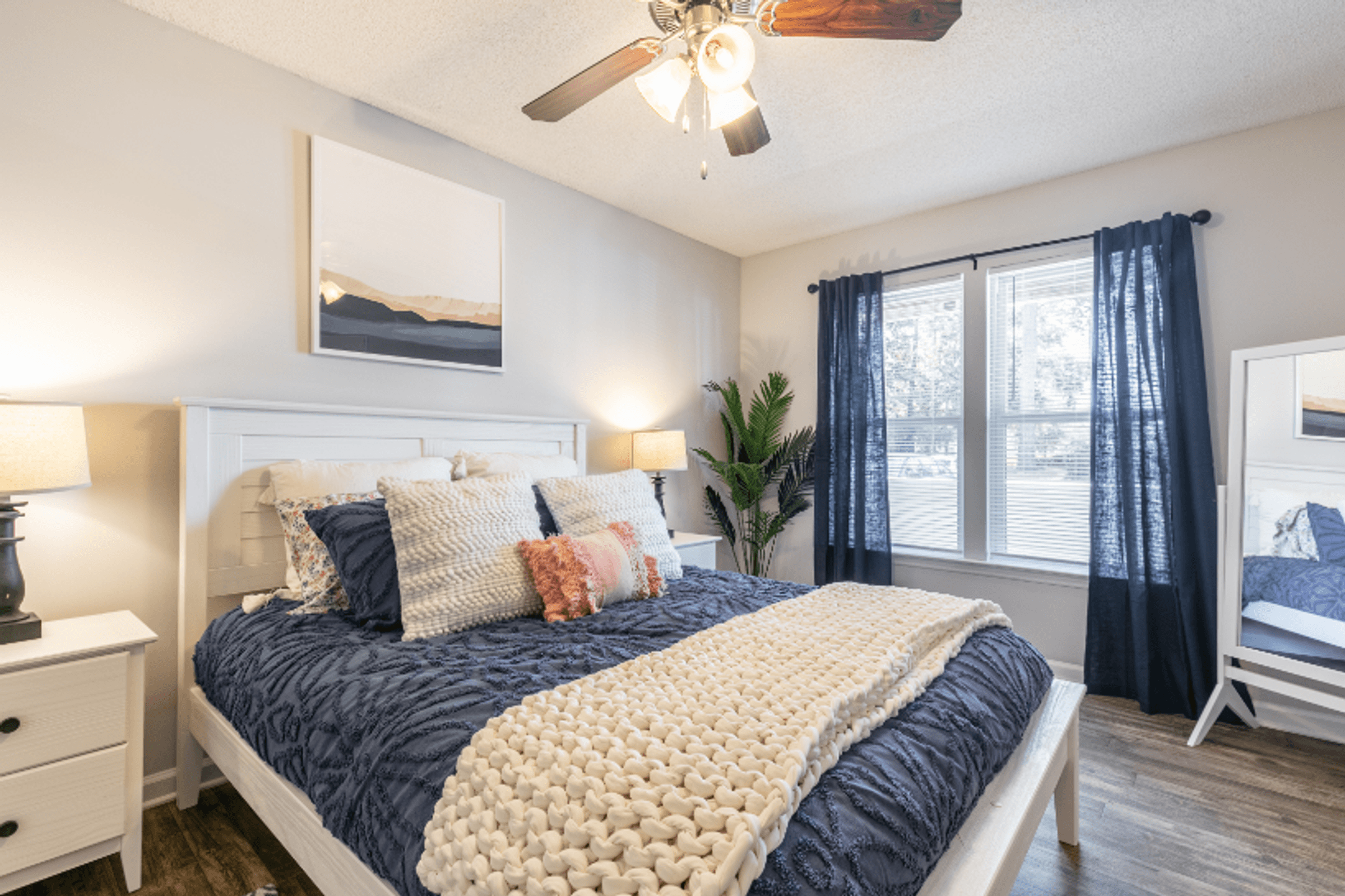 a bedroom with a bed and a ceiling fan