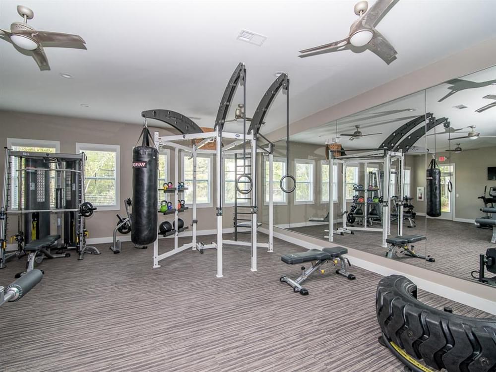 a gym with weights and equipments in a home for sale
