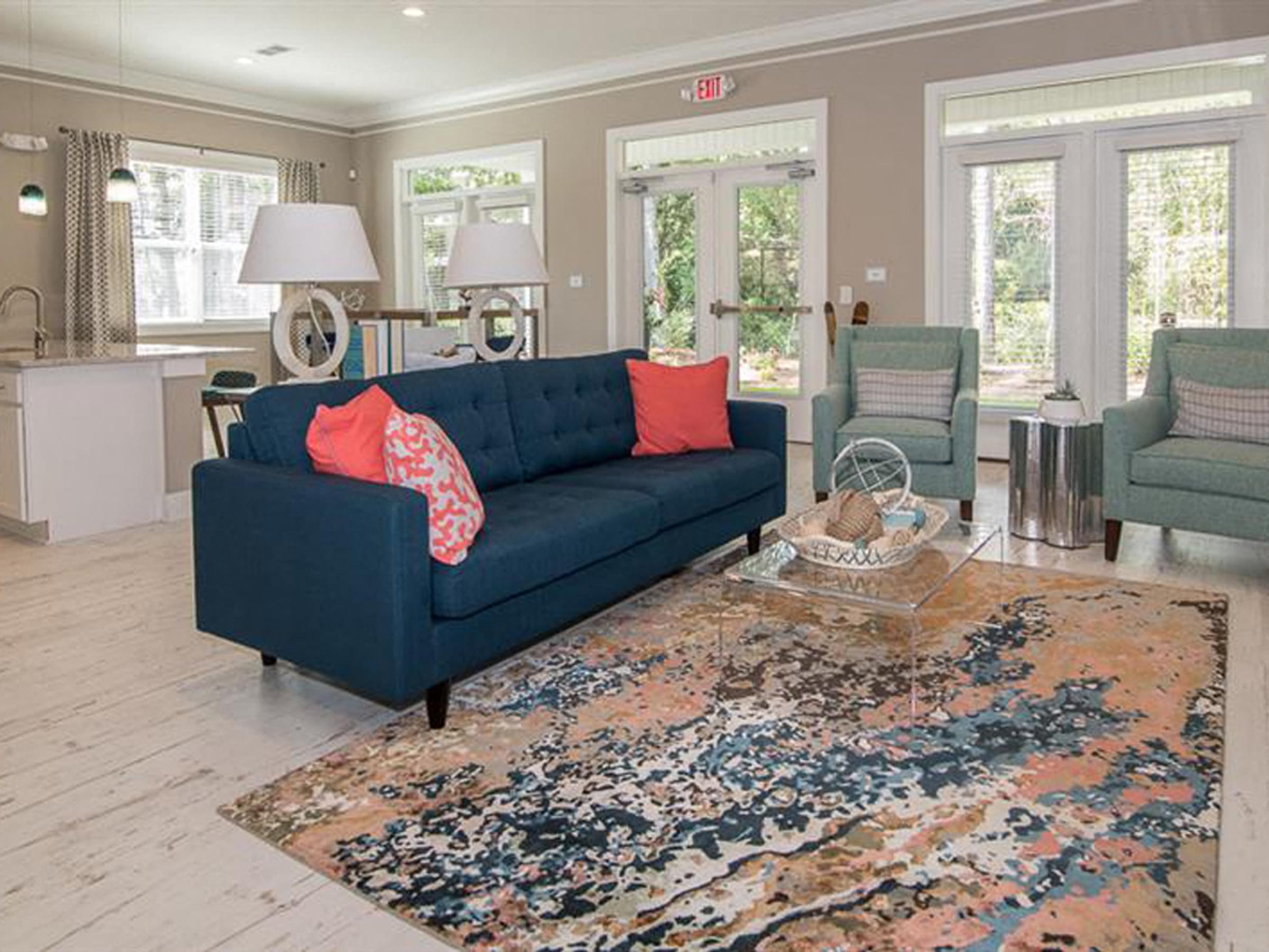 a living room with a blue couch and a rug