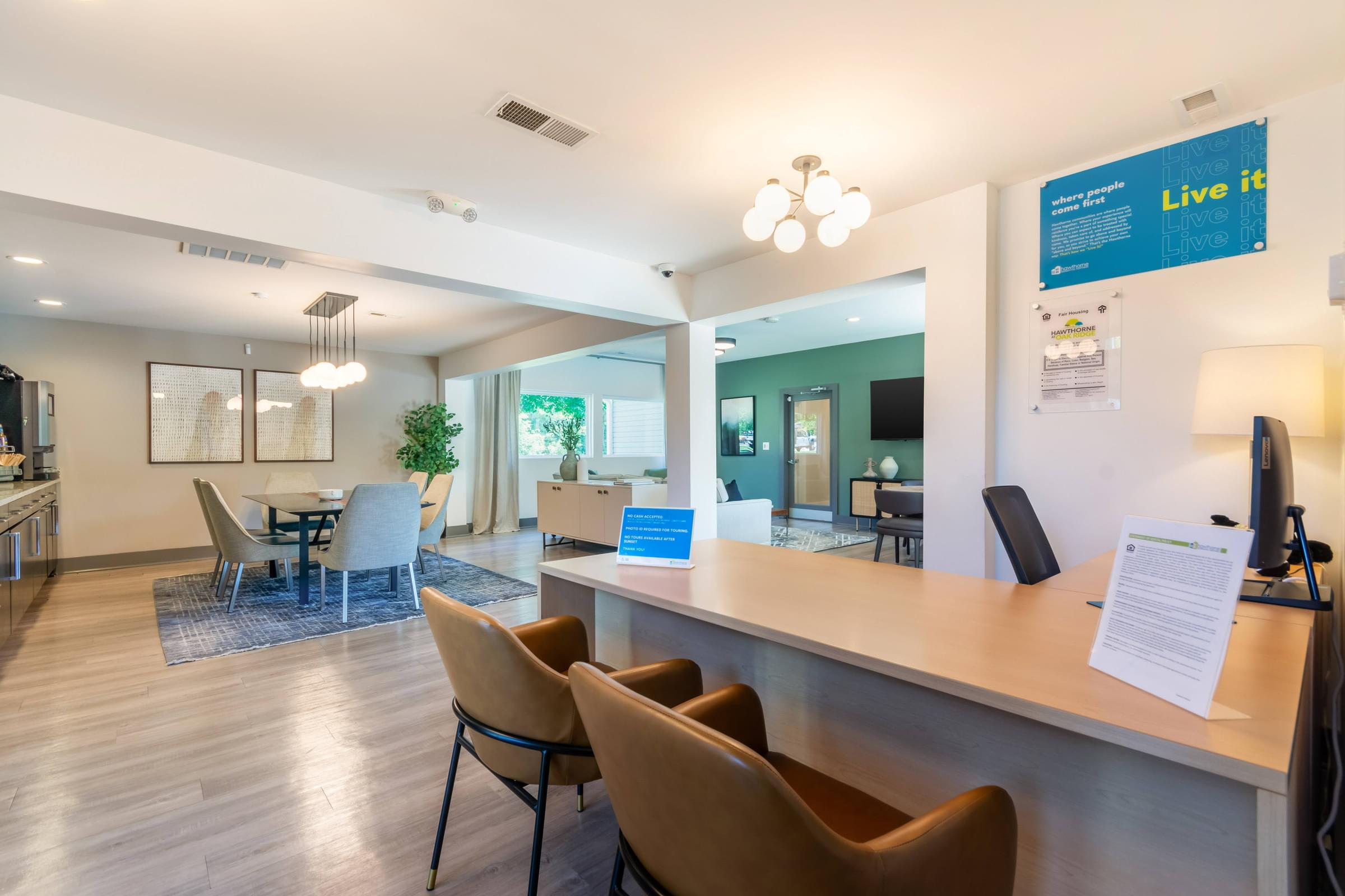 A reception area with a sign at Hawthorne at Oak Ridge in Greensboro, NC