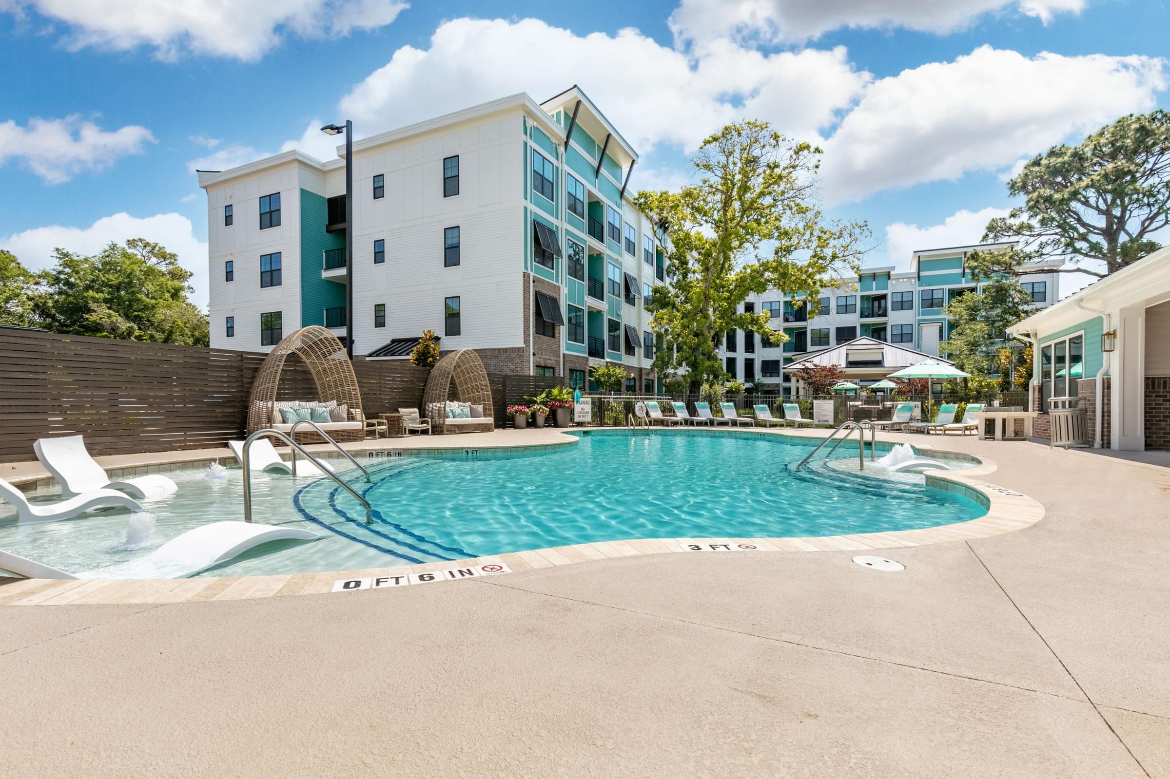 a swimming pool with a building in the background