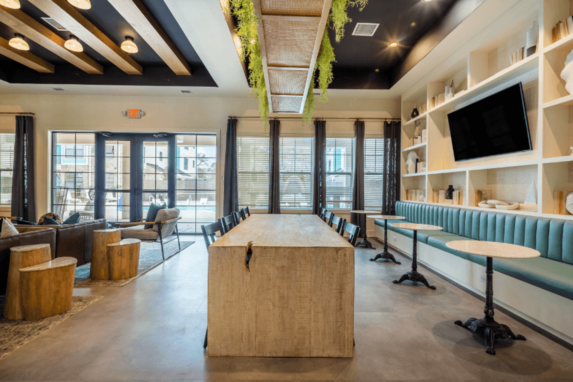 a conference room with a large table and chairs and a tv