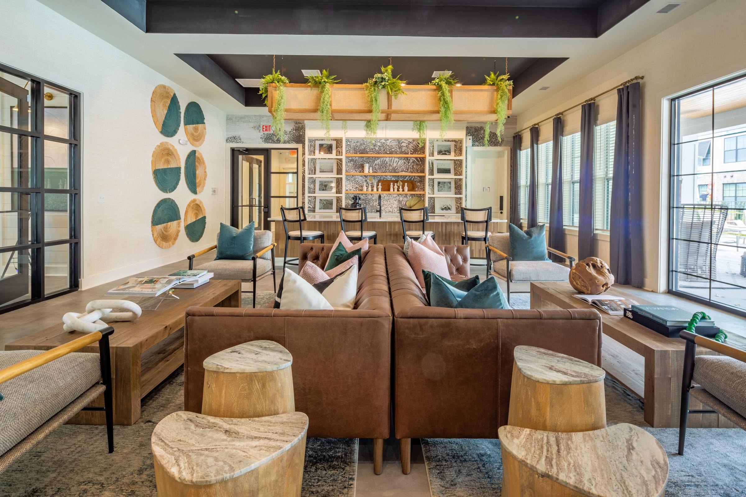 a living room with couches and tables and a bar