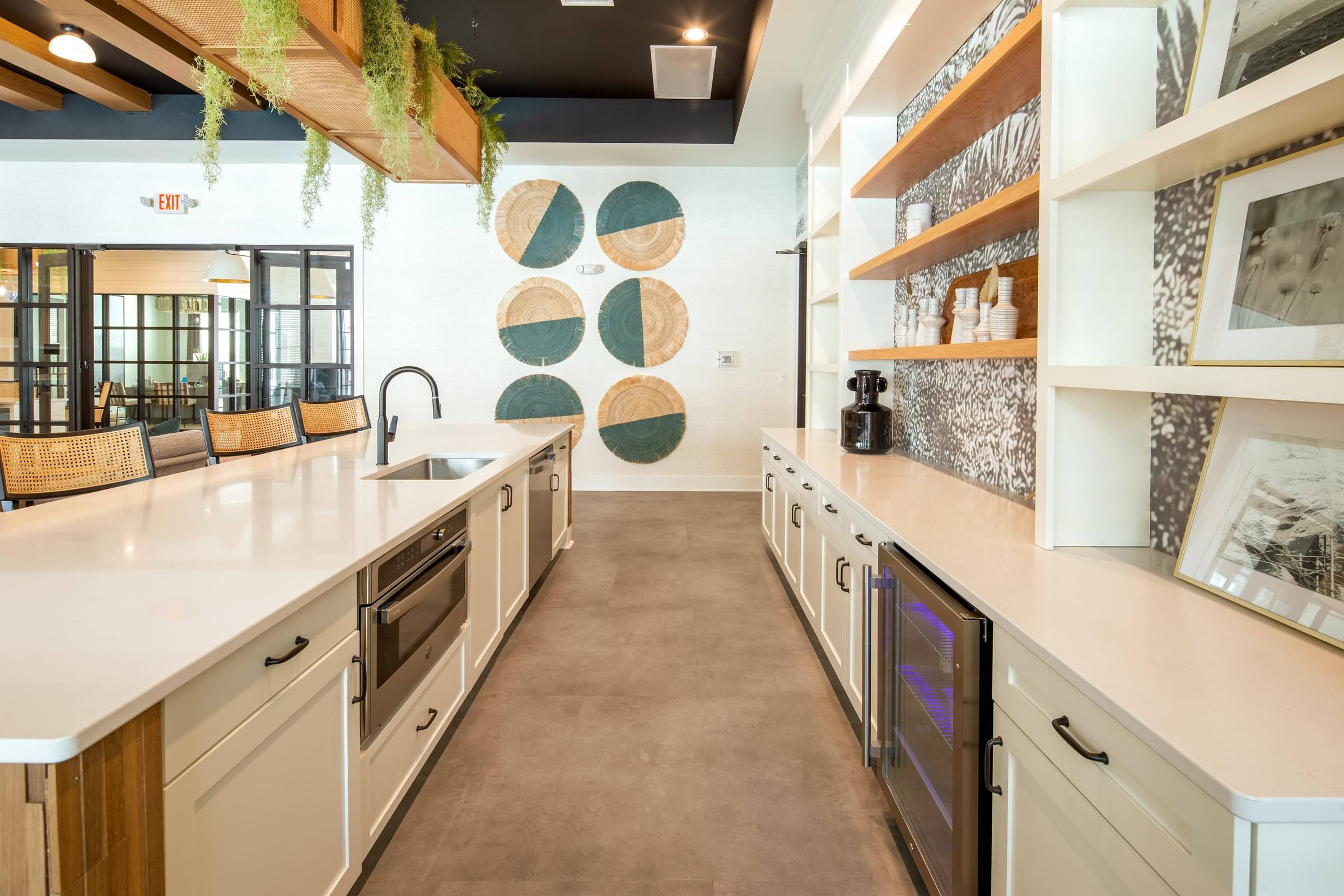 a large kitchen with white cabinets and counter tops and a sink