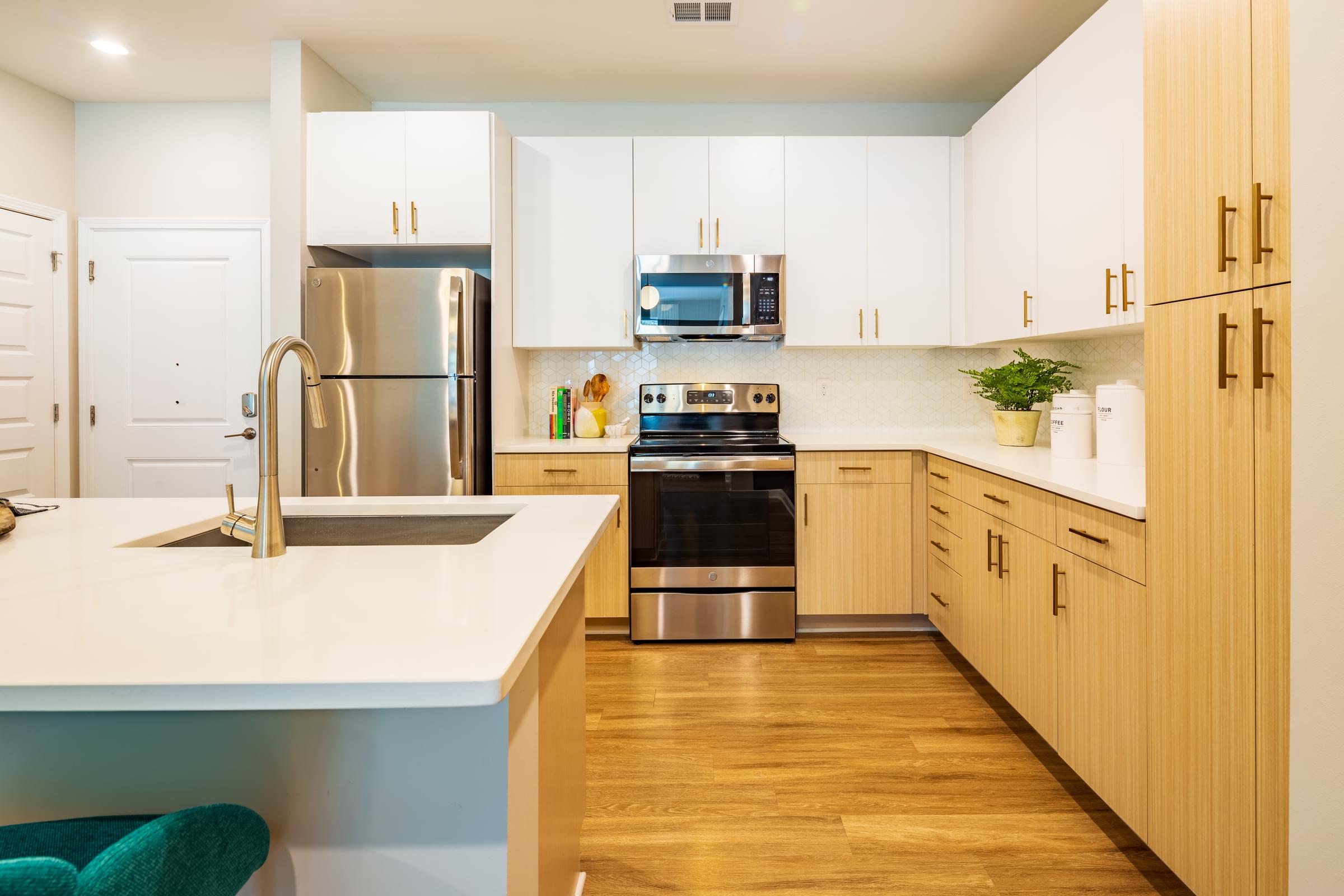 a modern kitchen with white cabinets and stainless steel appliances