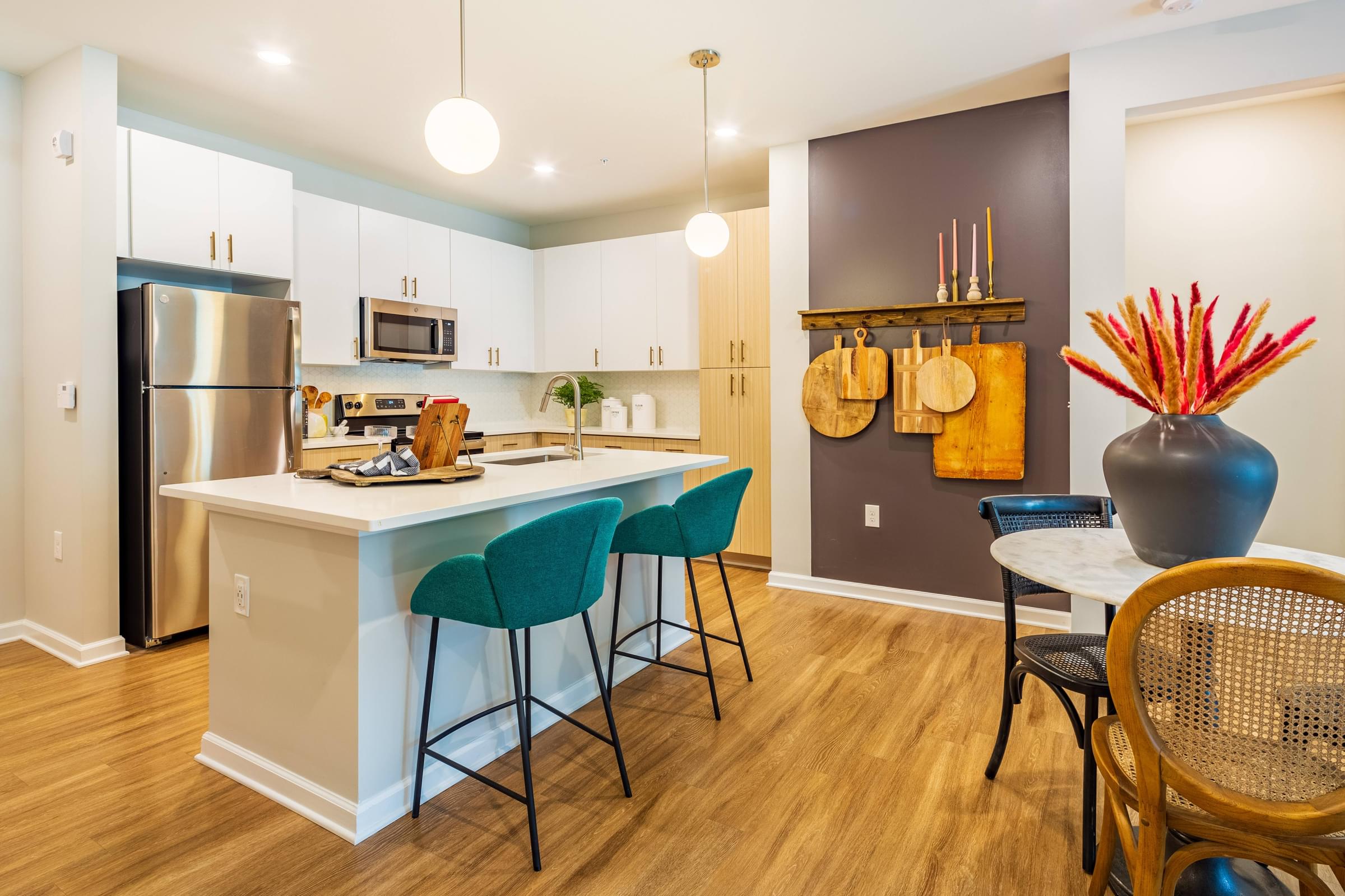 a kitchen with an island and a table with chairs