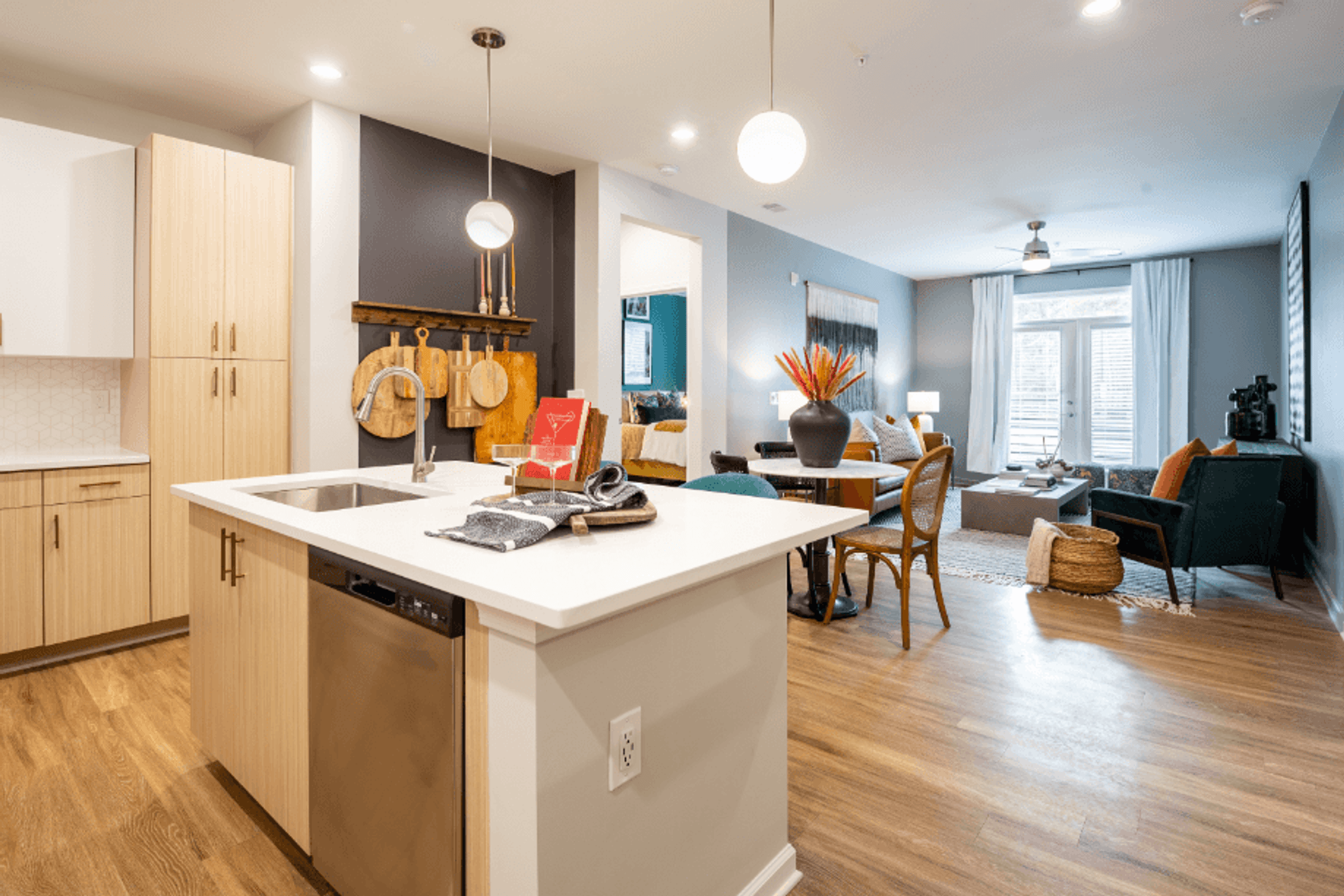 a kitchen with an island and a living room with a dining room