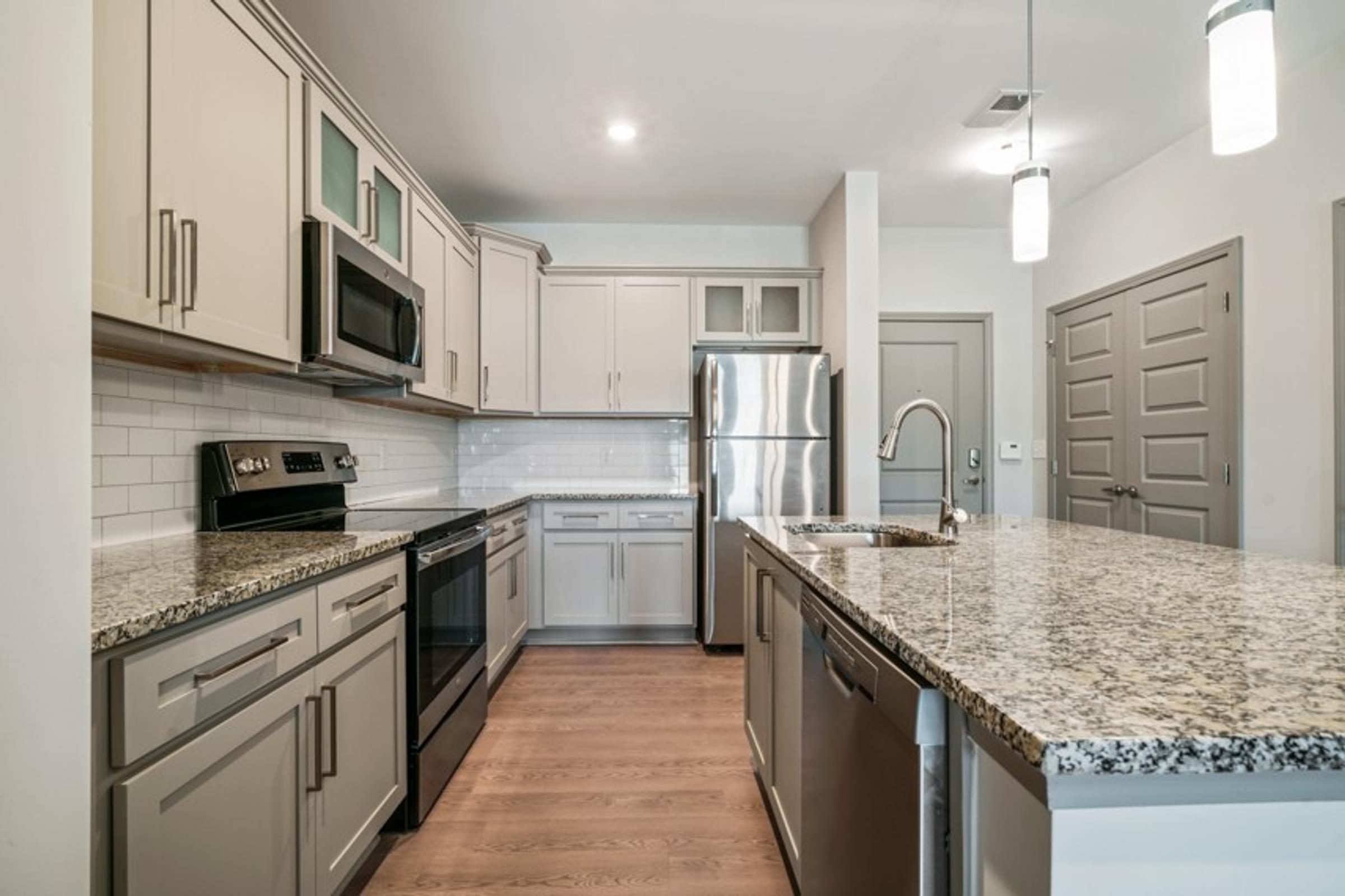 Large Kitchen with Stainless Steel Appliances and Grey Cabinets