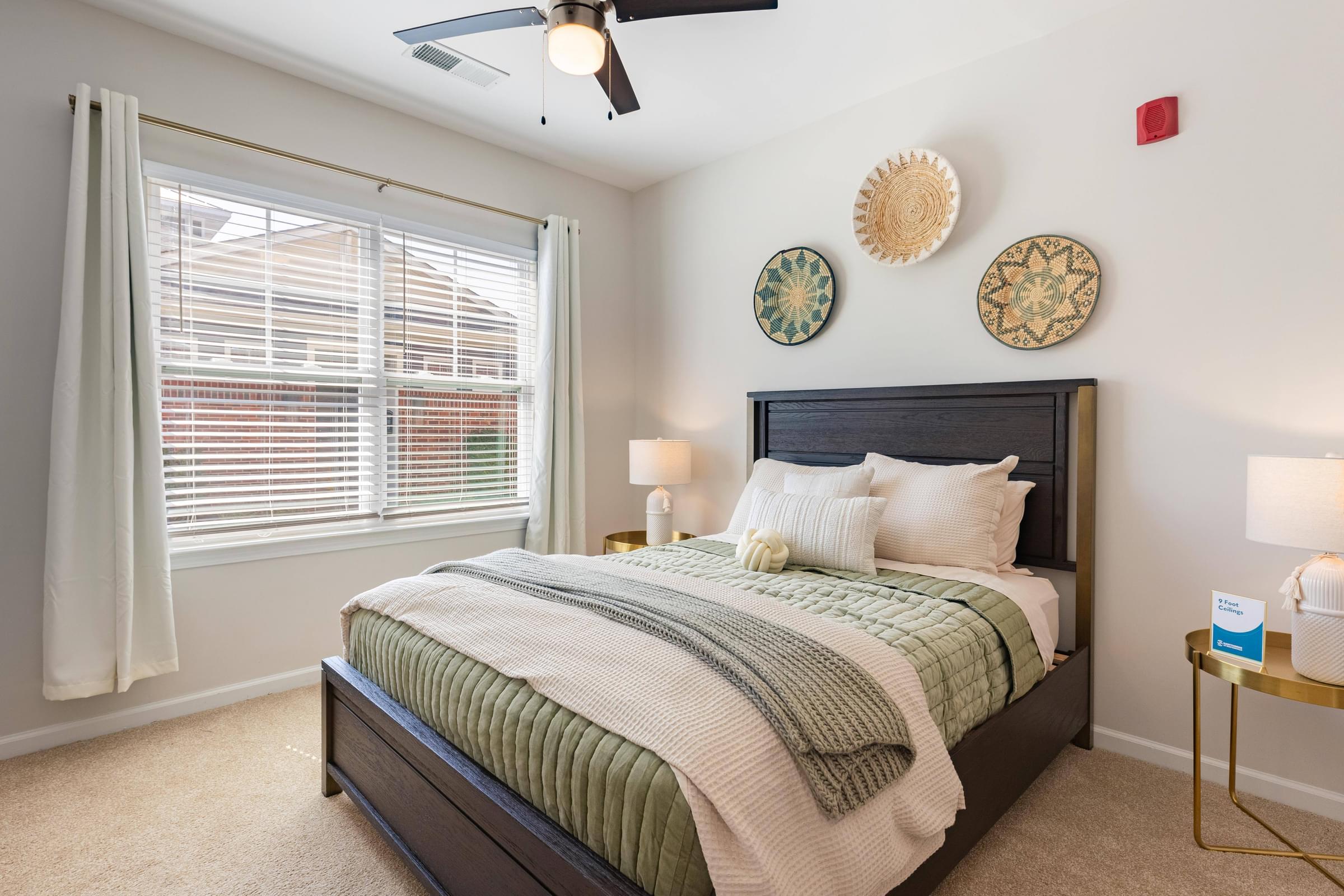 a bedroom with a bed and a large window