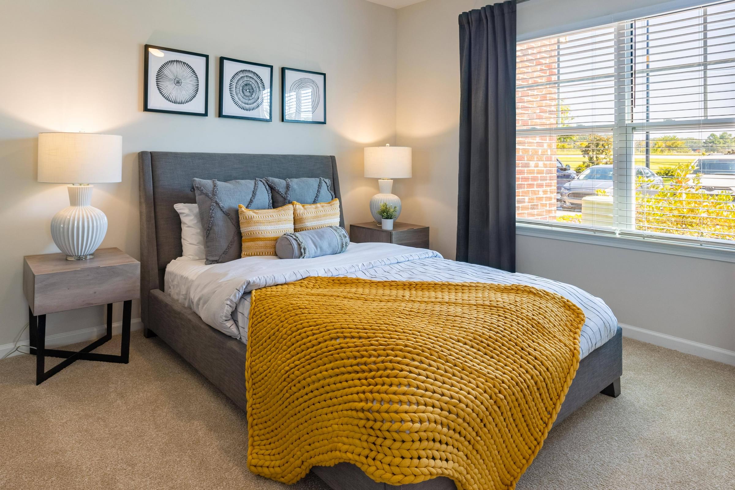 a bedroom with a bed and two windows