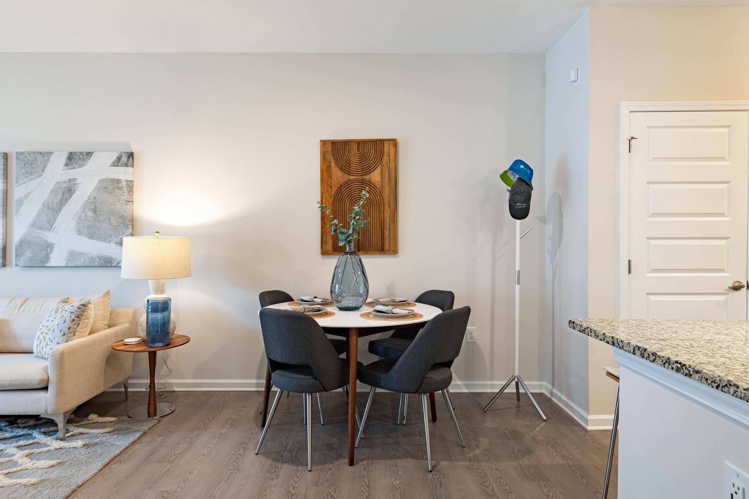 a dining room with a table with chairs and a vase