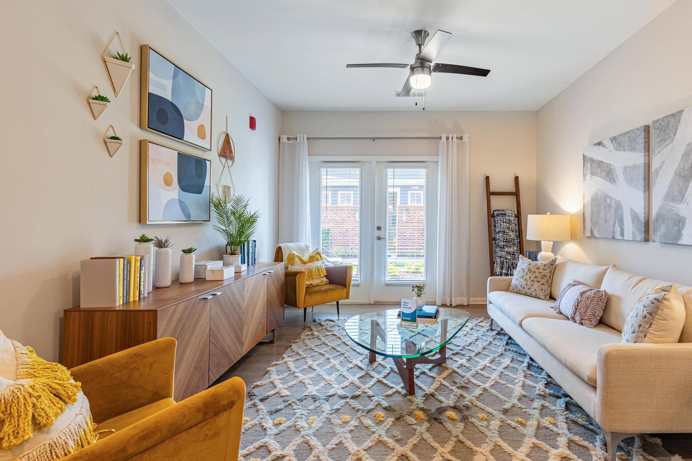 a living room with a couch and a ceiling fan