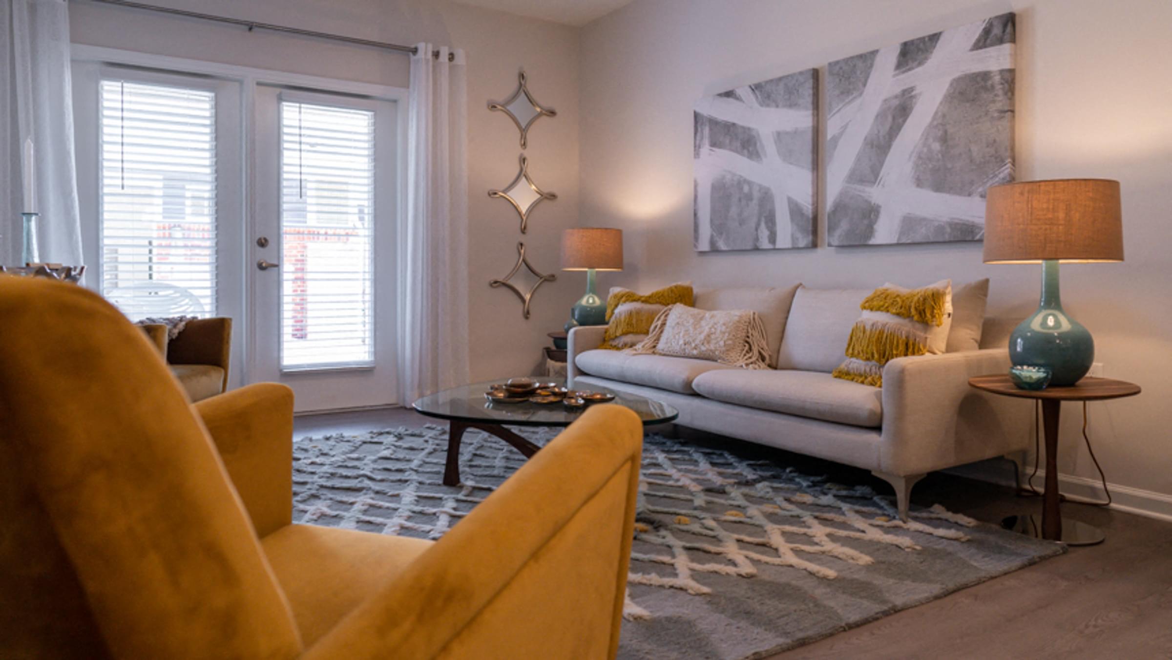 a living room with a couch and chairs and a table