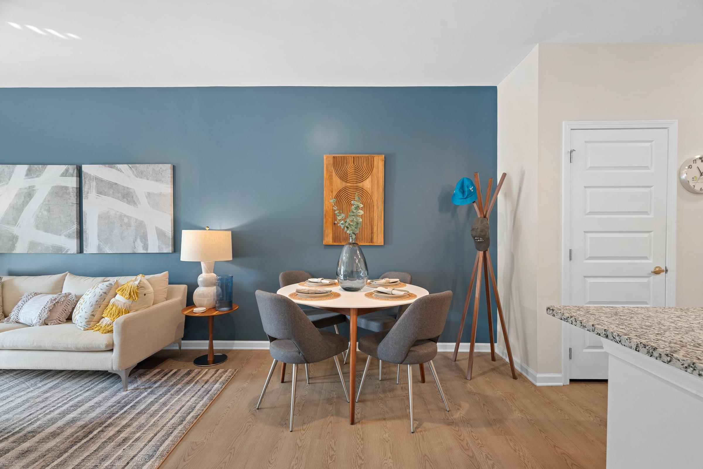 A dining area with a table set for four.
