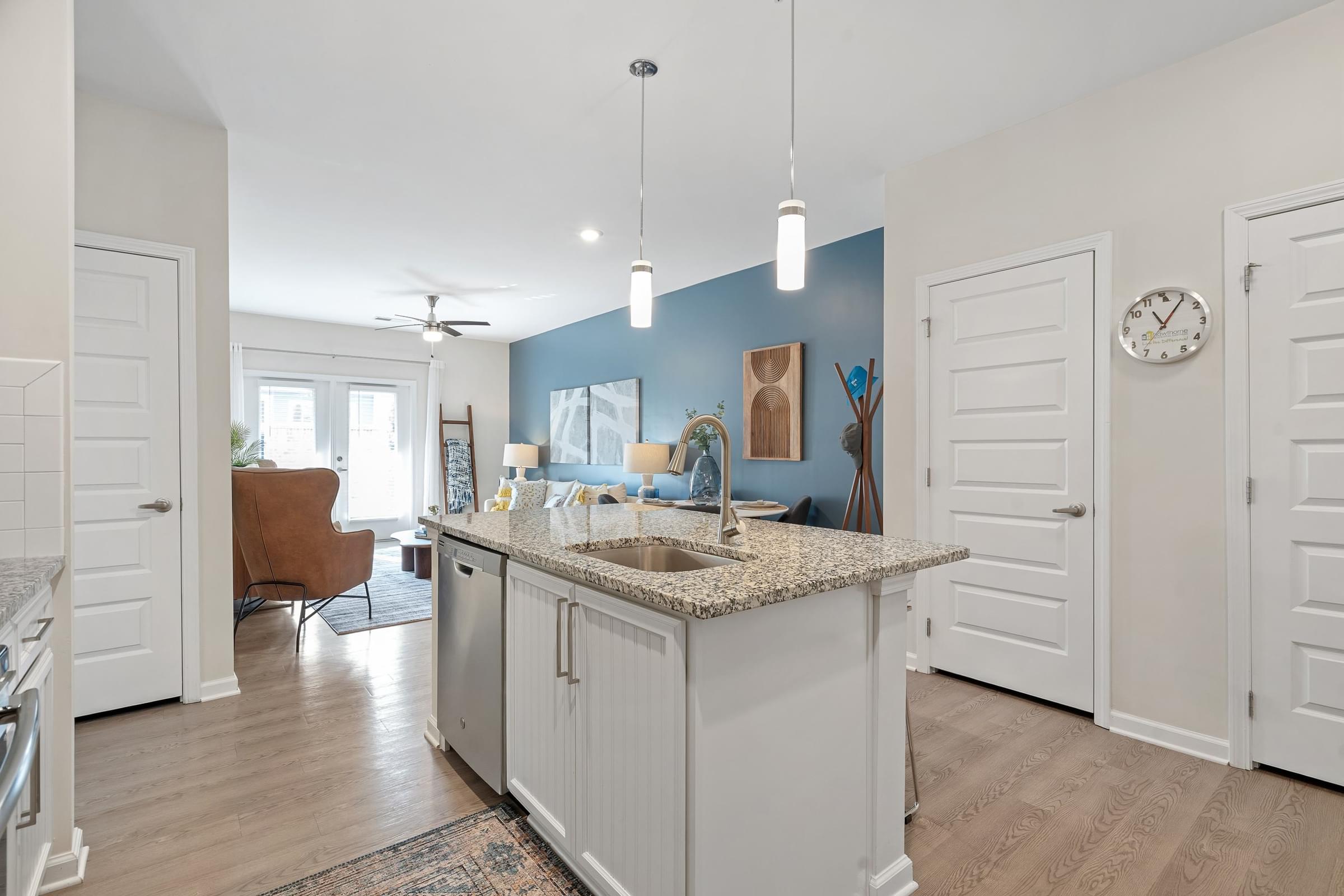 A kitchen with a large island and a ceiling fan.