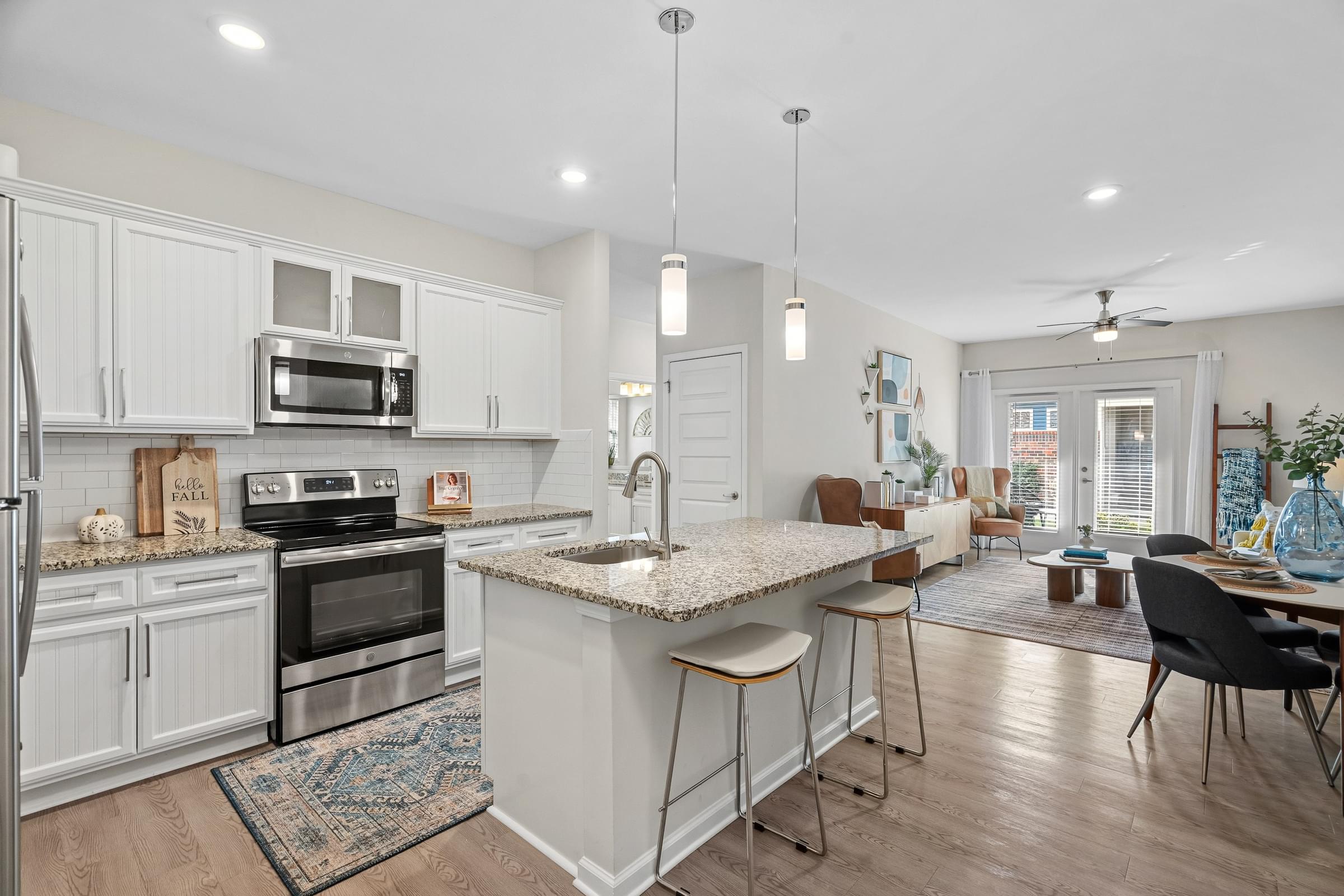 A kitchen with a white countertop and a stainless steel oven.