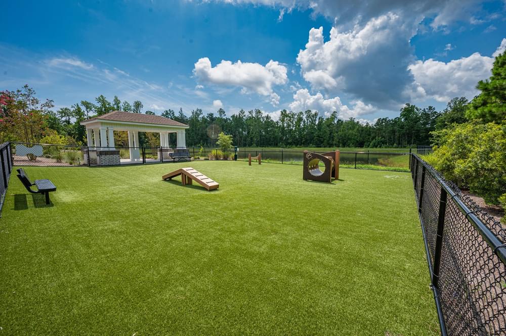 a backyard with a batting cage and a pool and a pavilion
