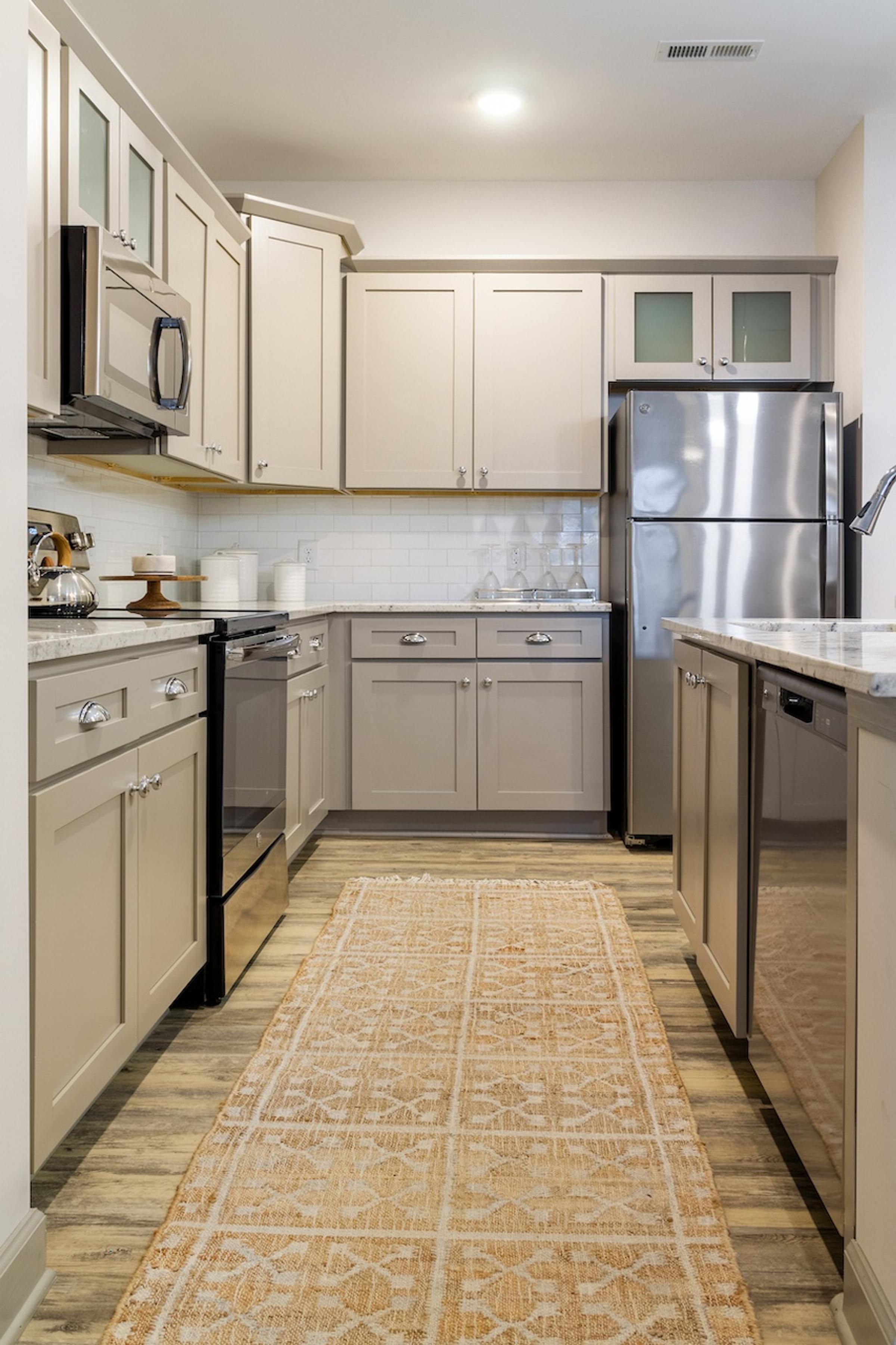 Fully Equipped Gourmet Kitchens with Granite Countertops and Designer Cabinetry