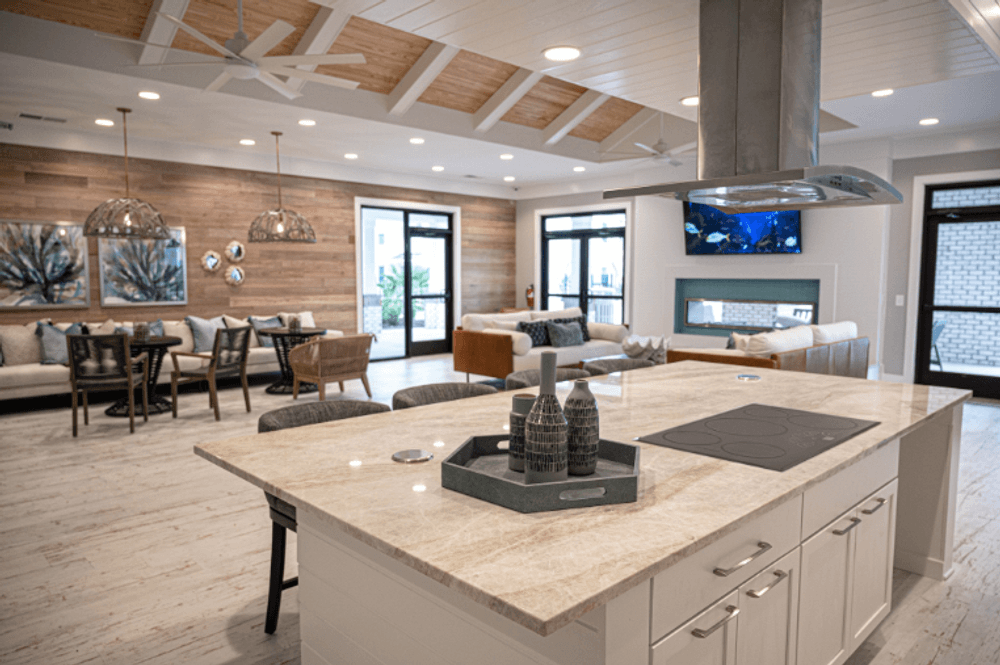 a kitchen with a large island and a living room with a fireplace