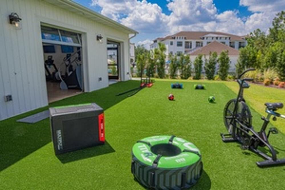 a home gym with a bike and a generator on the grass