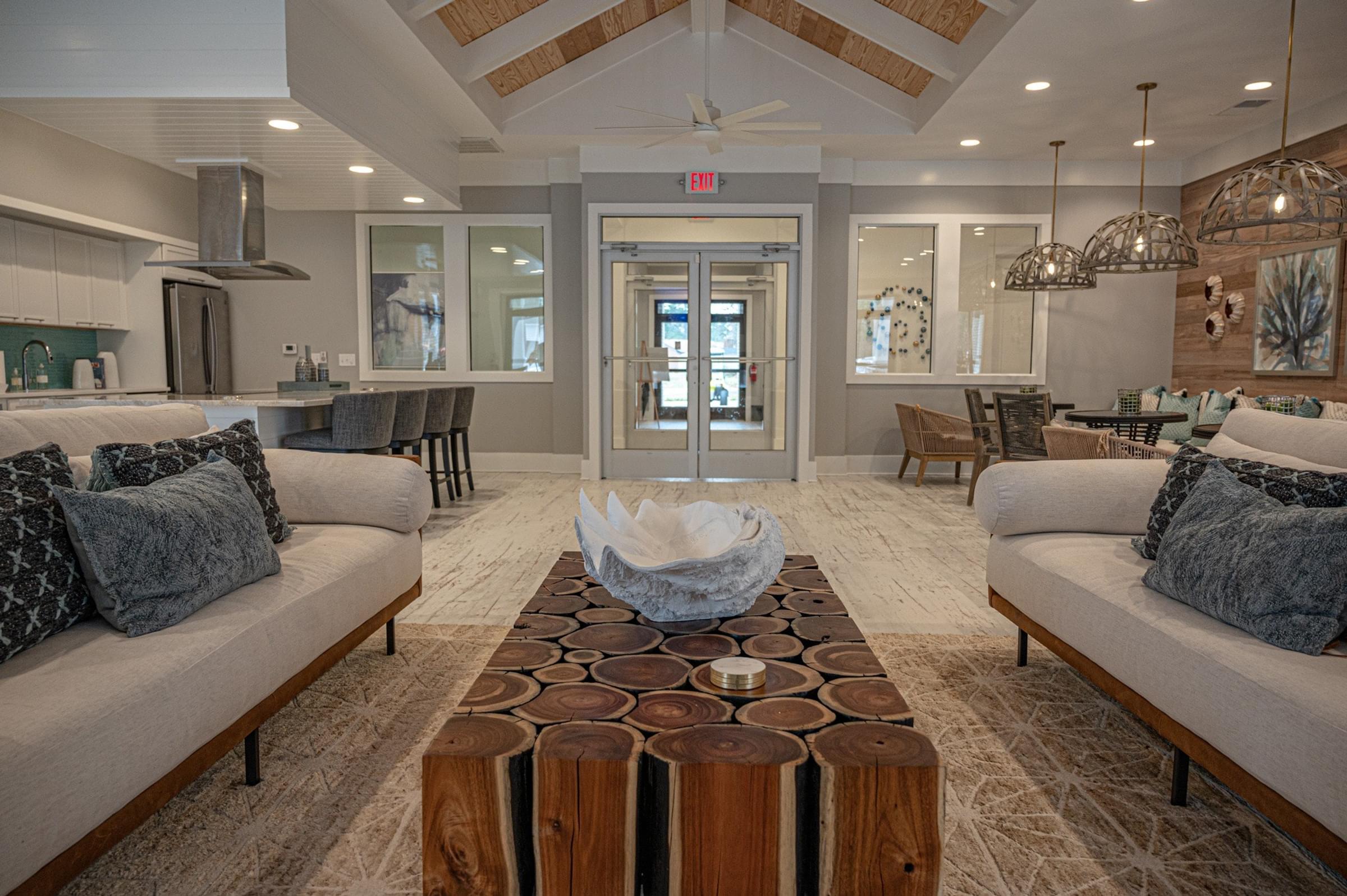 A modern living room with a wooden coffee table in the center.