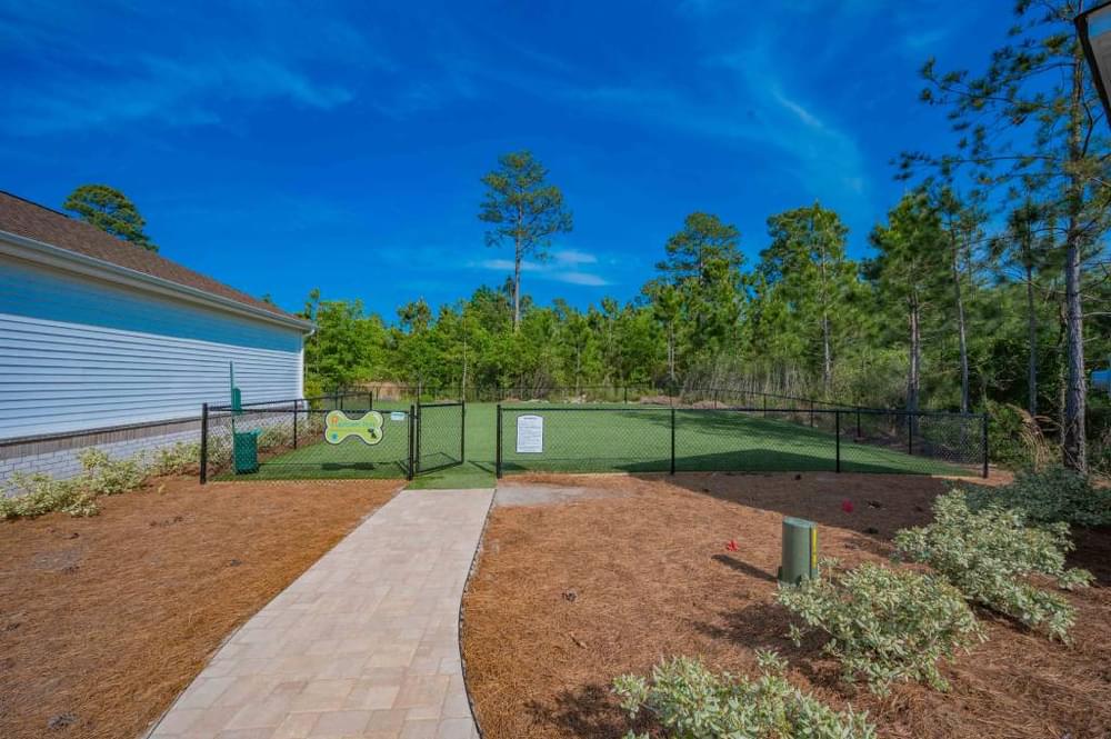 a tennis court in the backyard of a house with a chain link fence