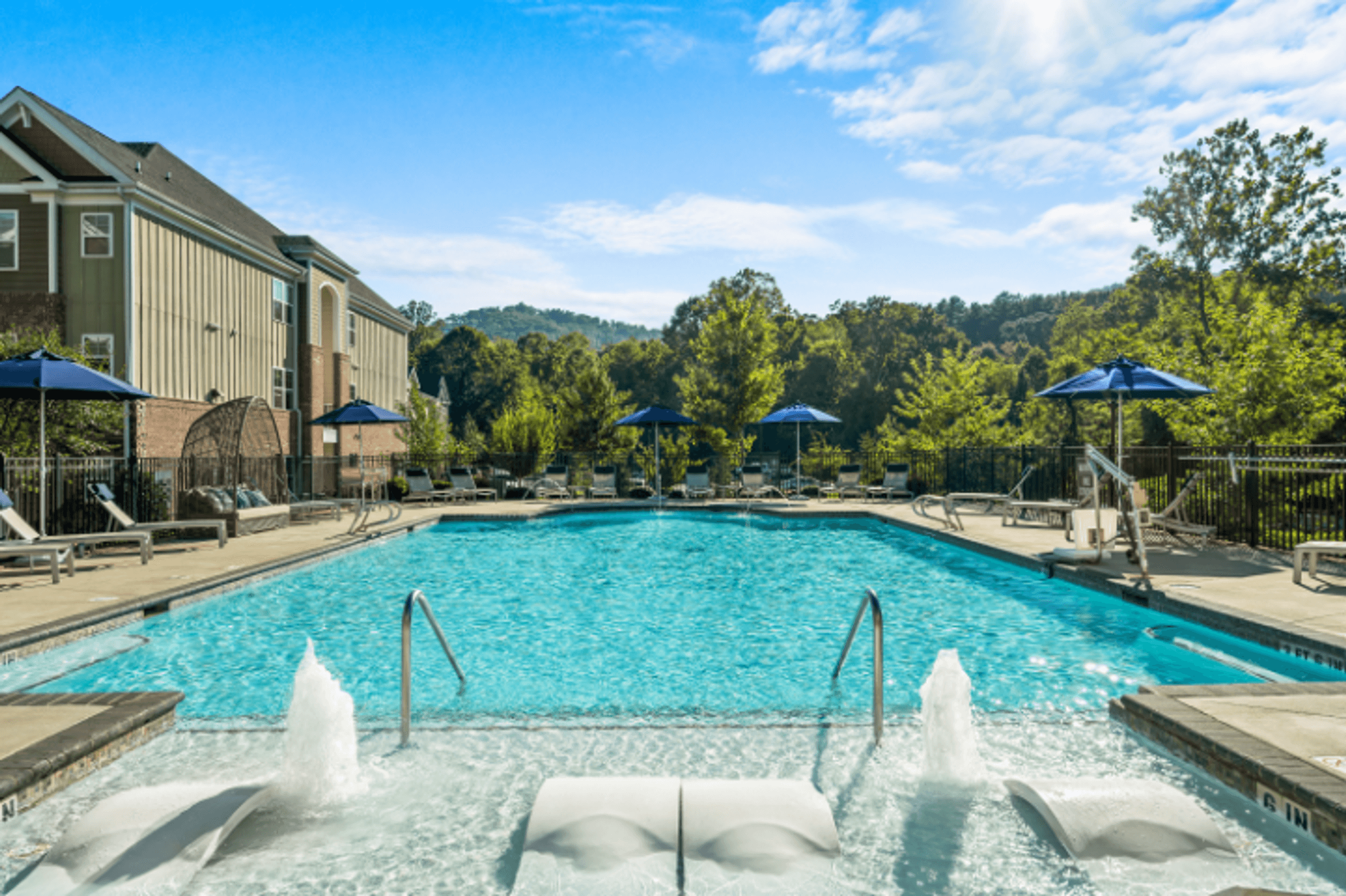 our resort style swimming pool is surrounded by our buildings and umbrellas