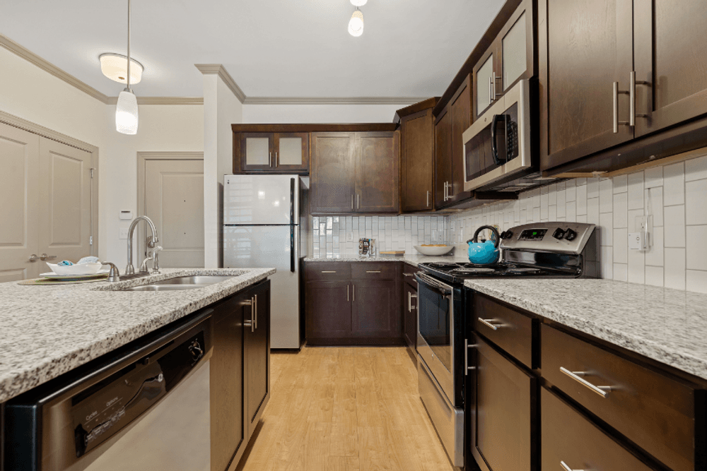 full kitchen with granite counter tops and stainless steel appliances and dark wood cabinets