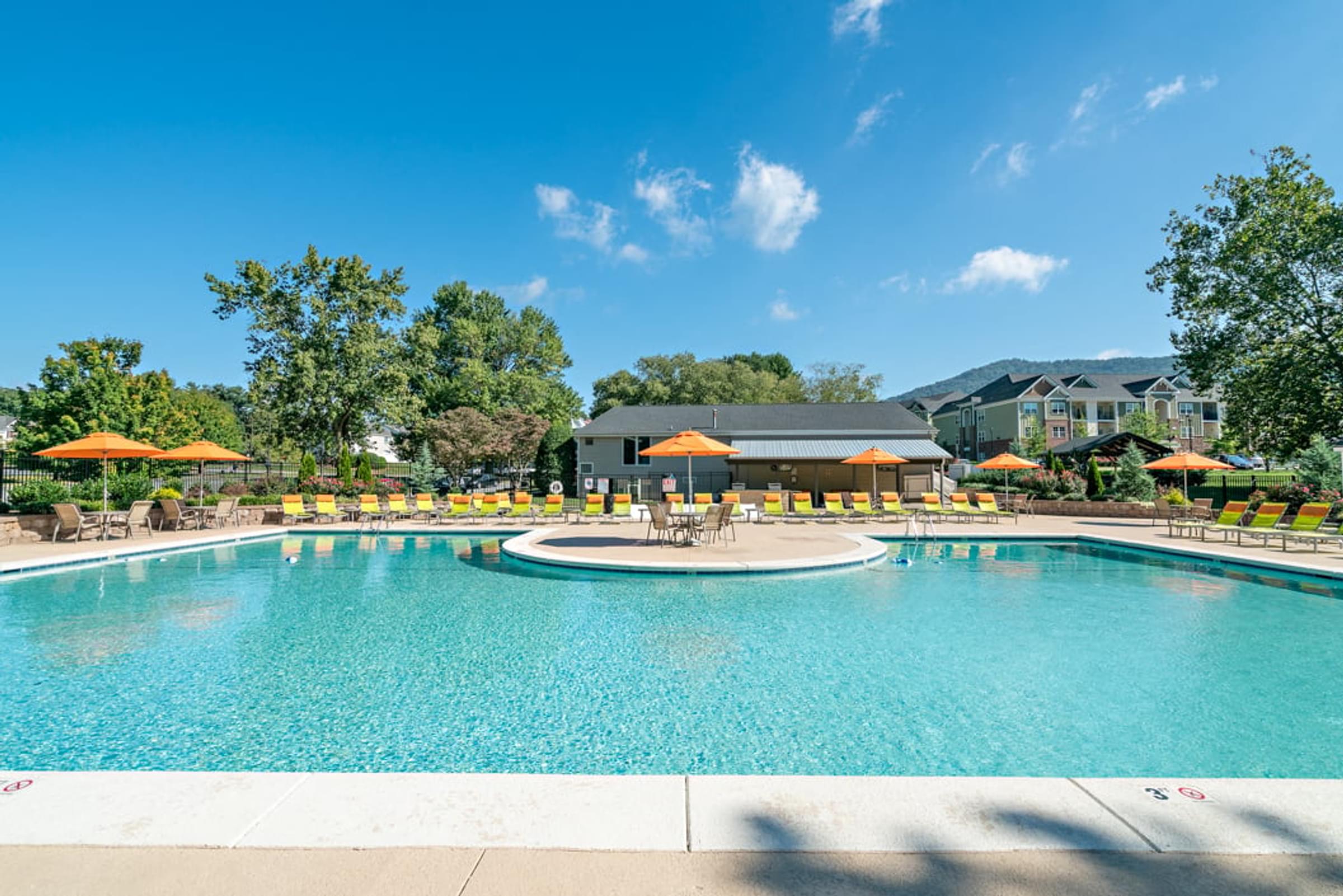 Large Resort Style Swimming Pool with Lounge Chairs and Umbrellas