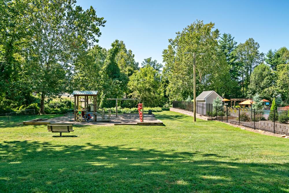 a park with a playground and a swing set