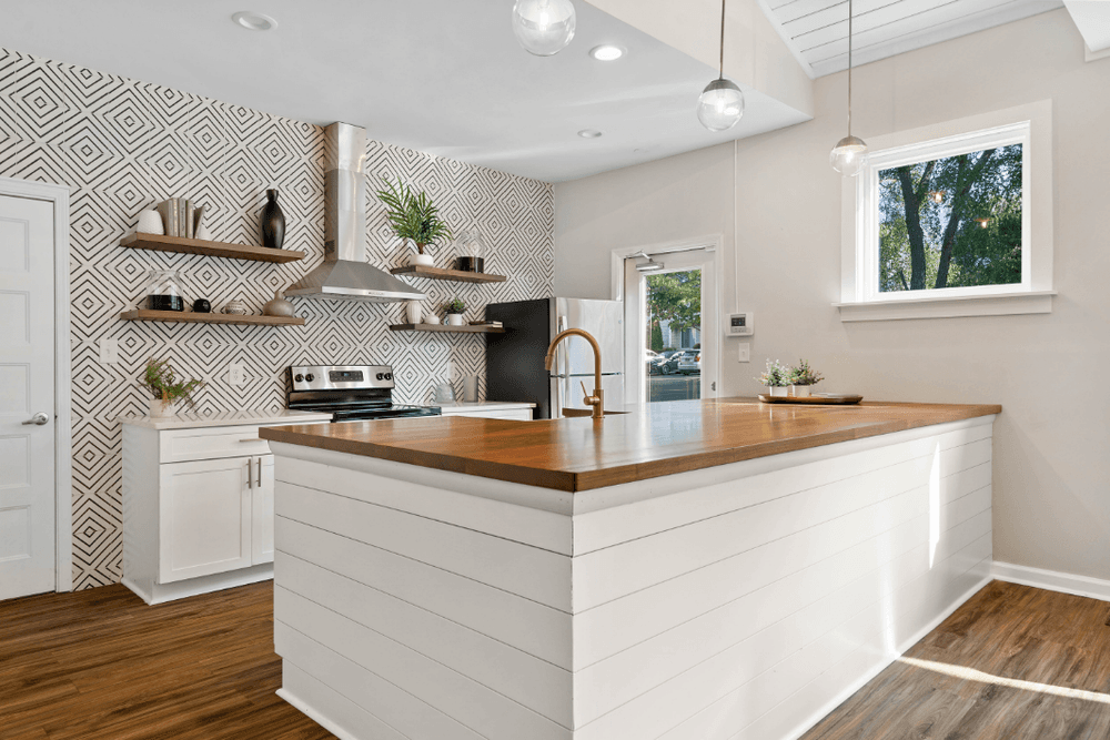 a white kitchen with a wooden counter top