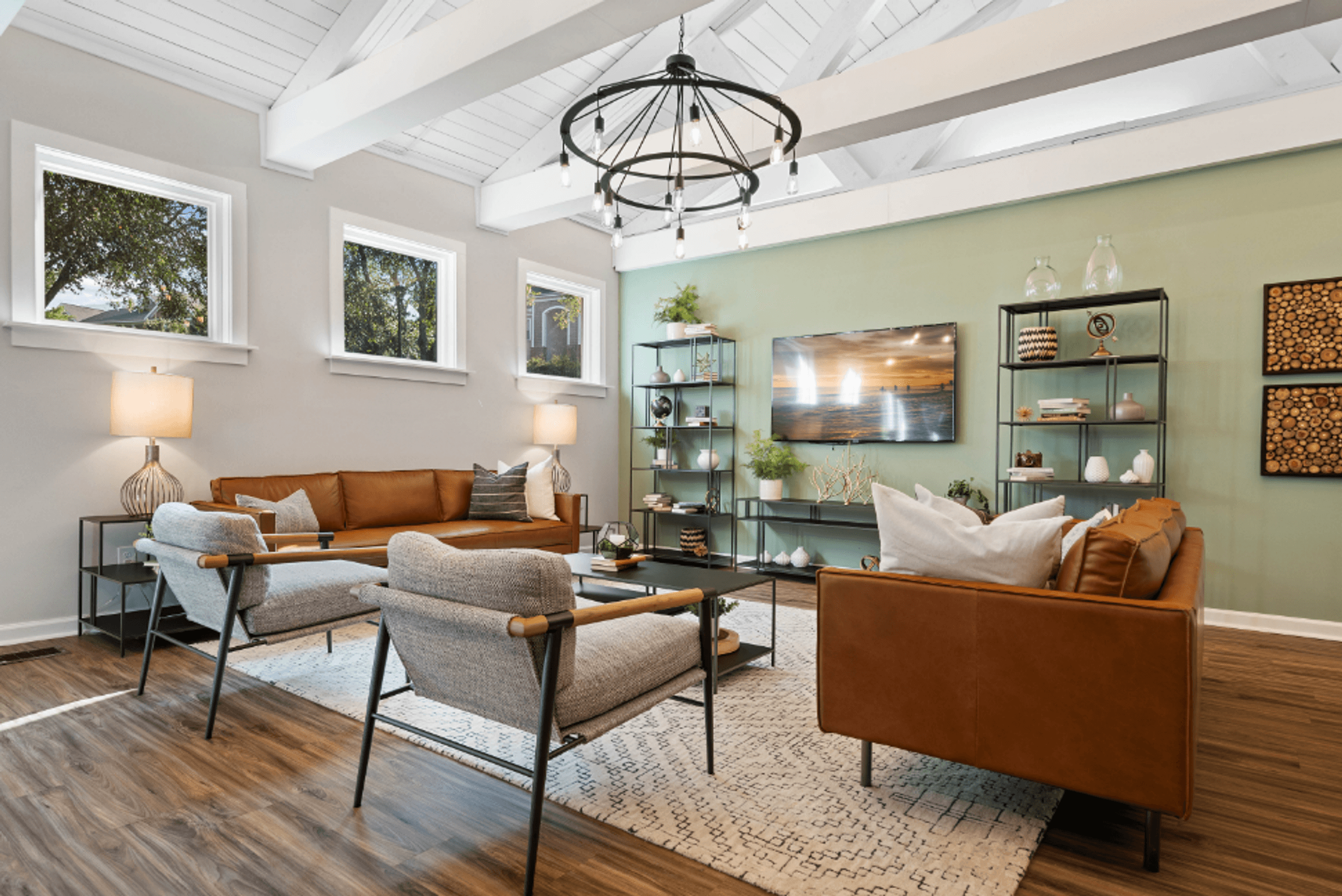 clubhouse room with couches and chairs and a tv