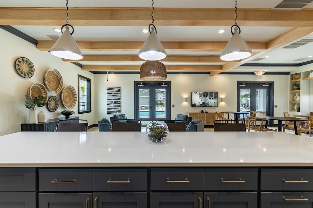the kitchen and living room of a home with a large counter top