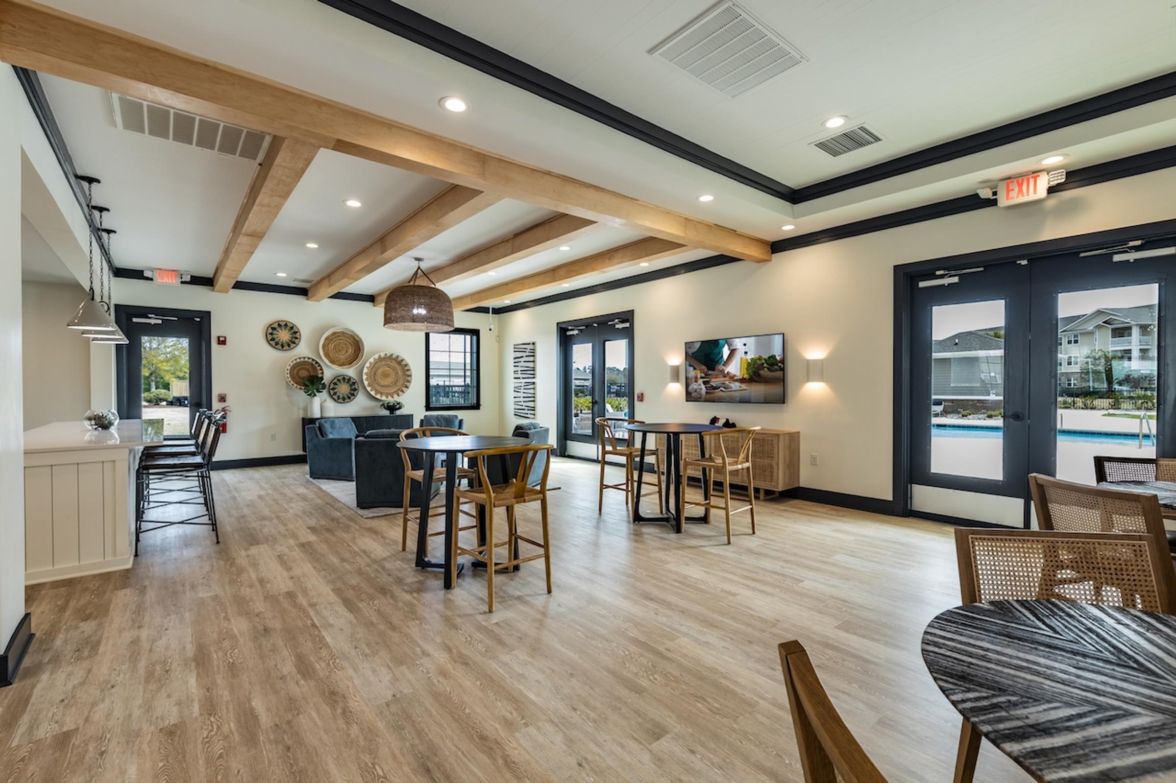 the reserve at the falls lobby with tables and chairs and a tv