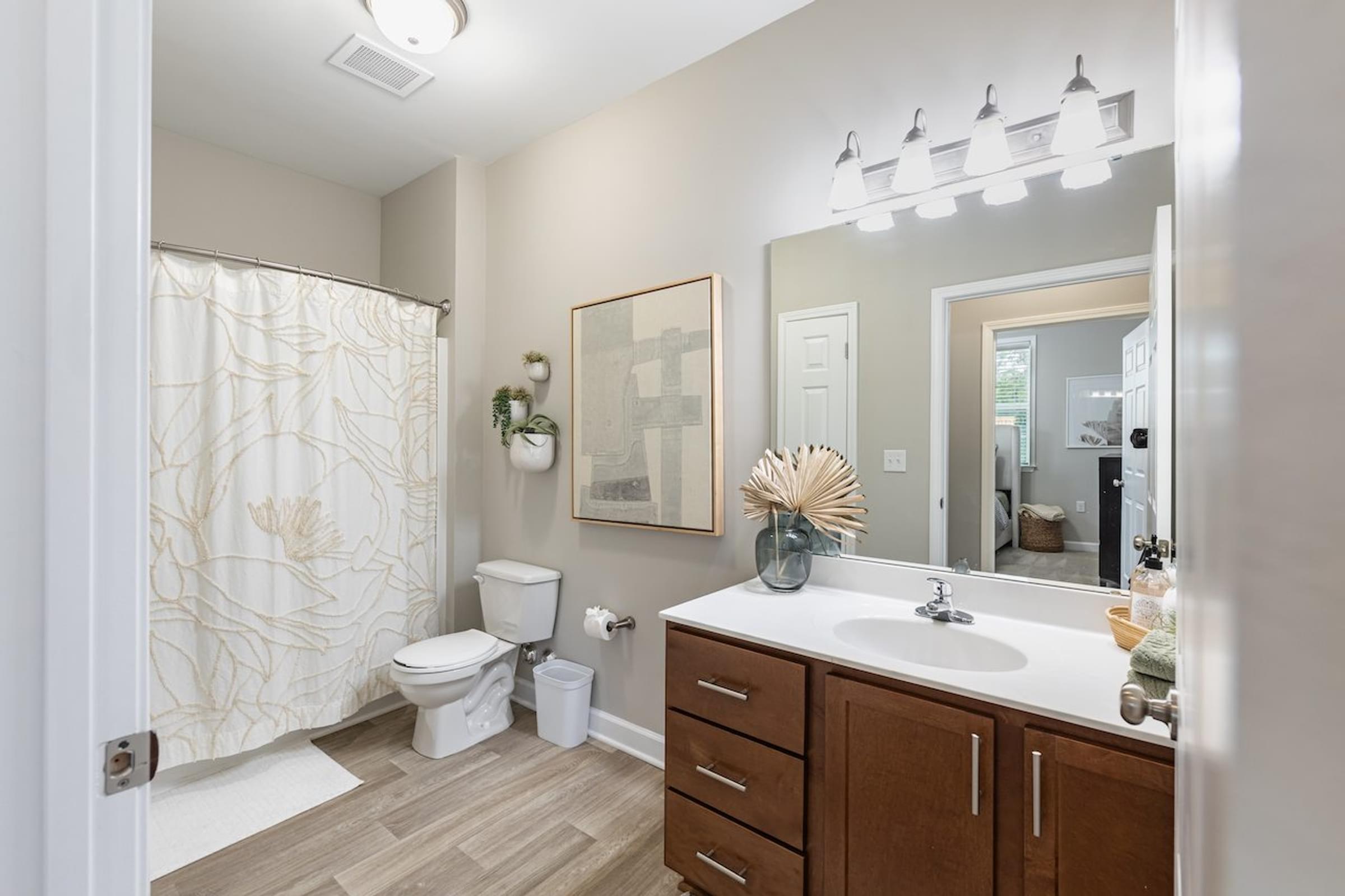 a bathroom with a sink and a shower and a toilet