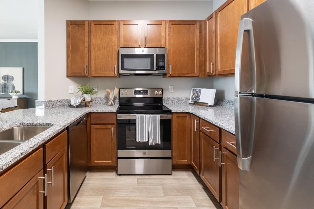 full kitchen with stainless steel appliances and granite counter tops