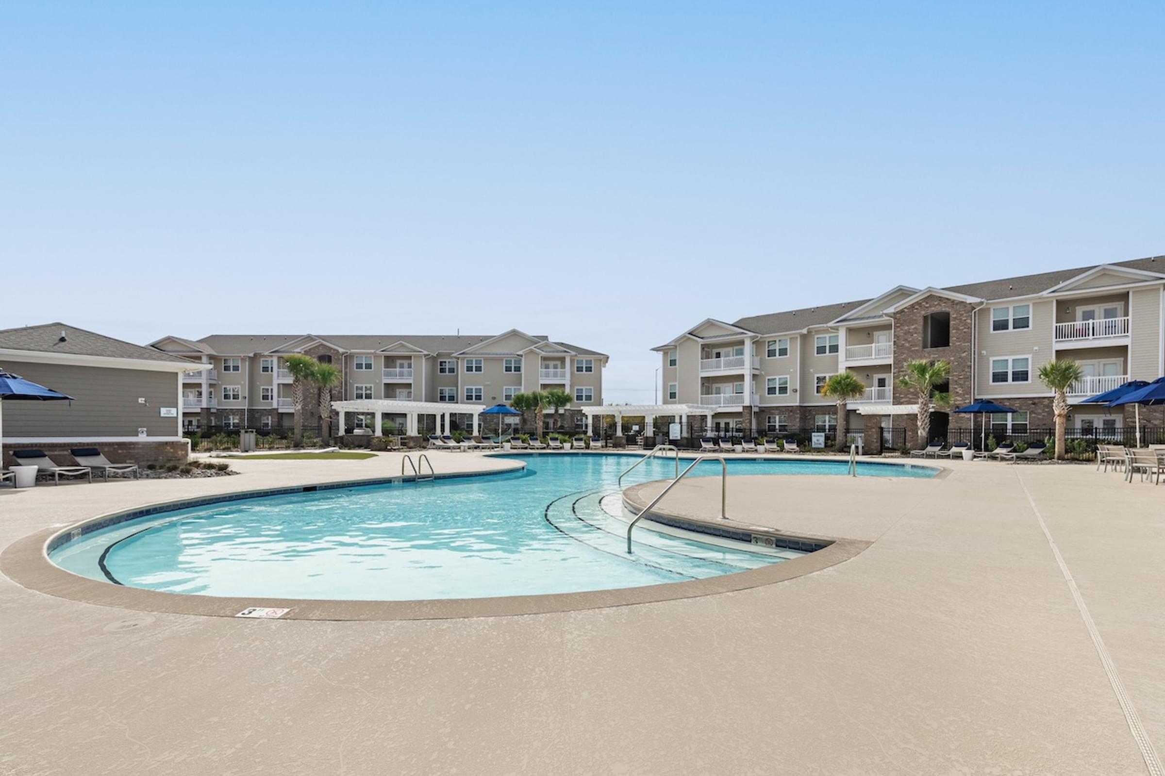 a swimming pool with apartments in the background