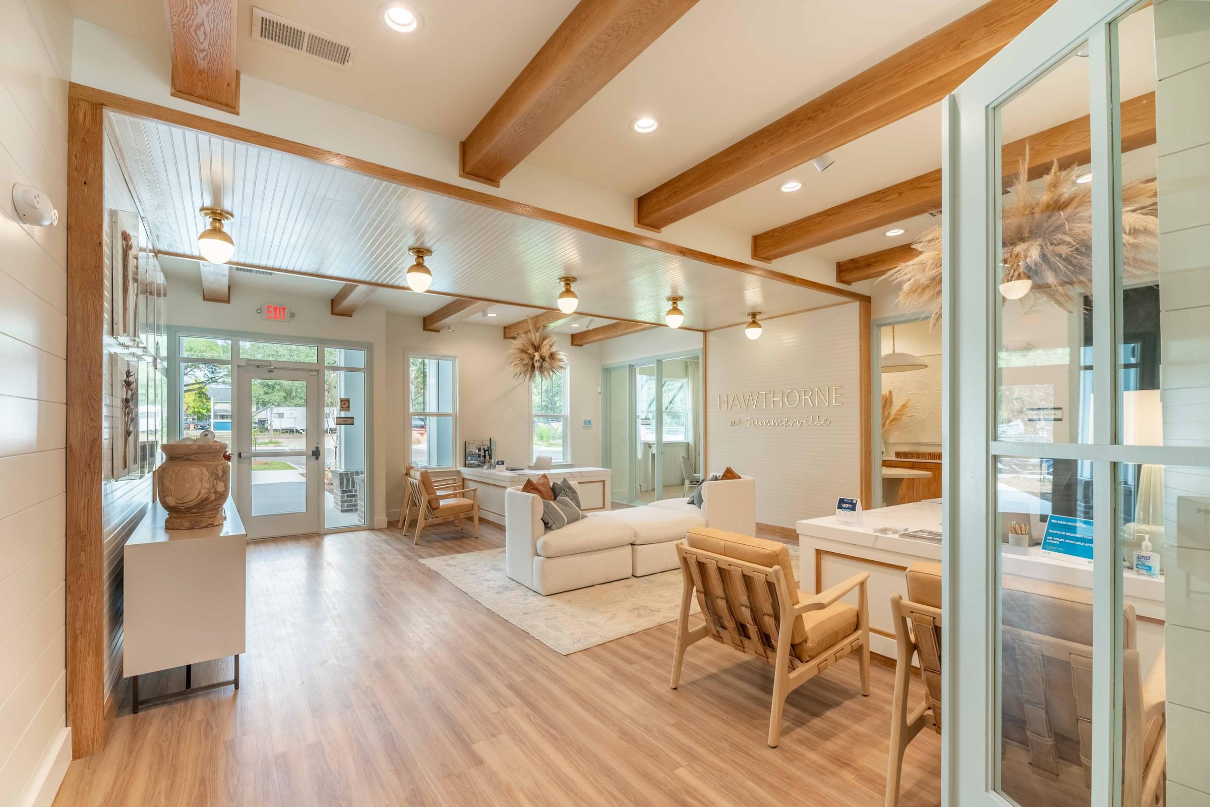 a living room and dining room with wood floors and glass doors