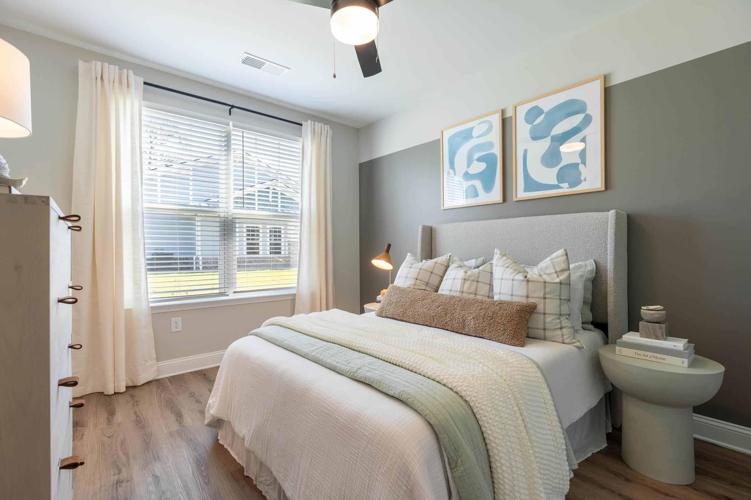 a bedroom with a bed and a toilet and a window