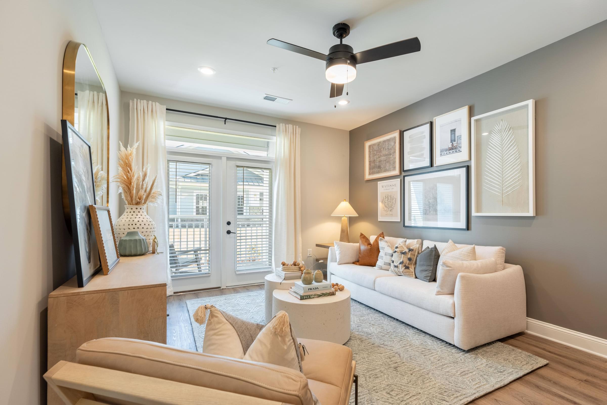 Living Room with Wood Plank Flooring, Ceiling Fan, and Patio